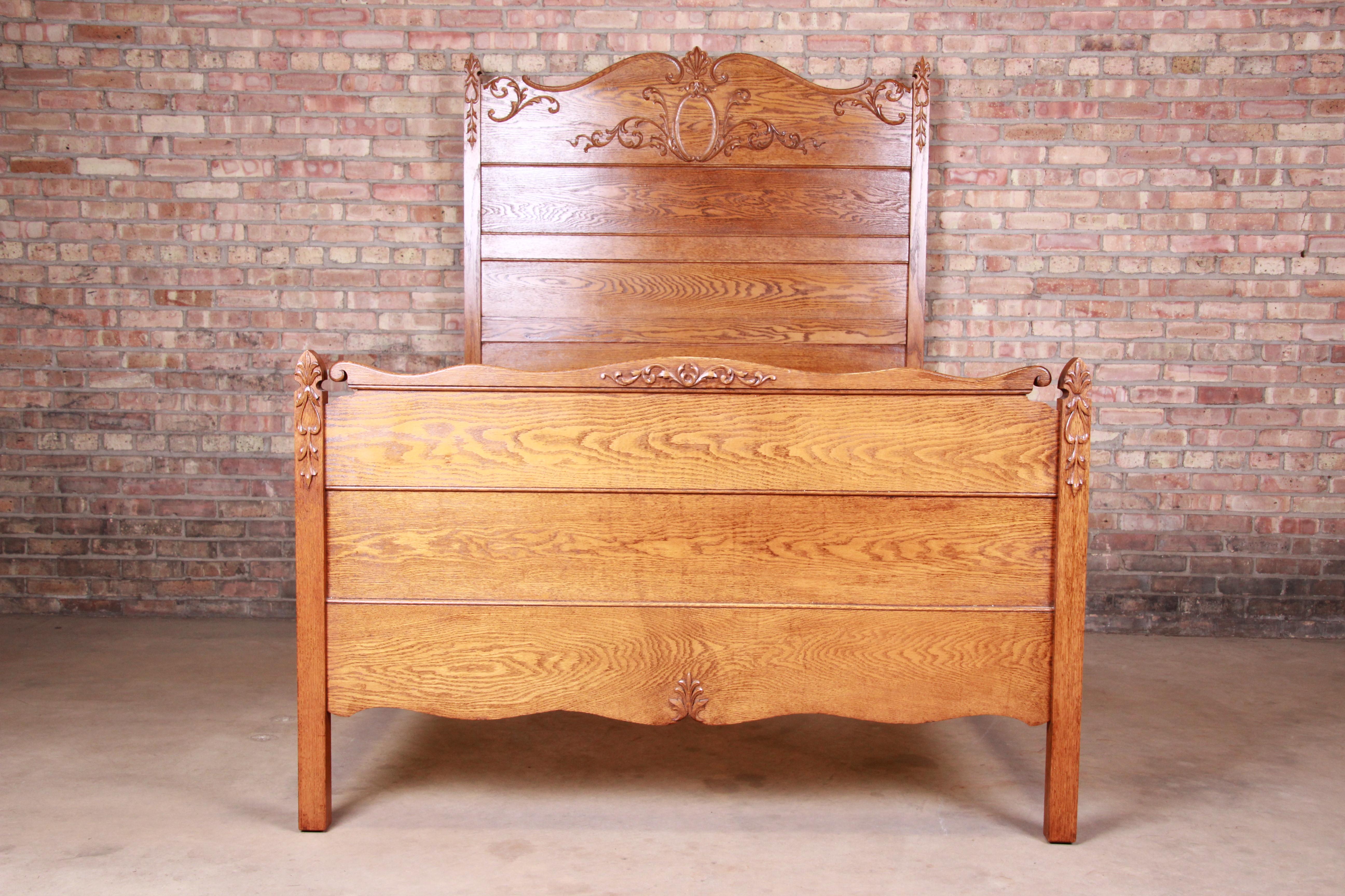 A gorgeous antique carved oak full size bed frame

USA, circa 1900

Measures: 56.63