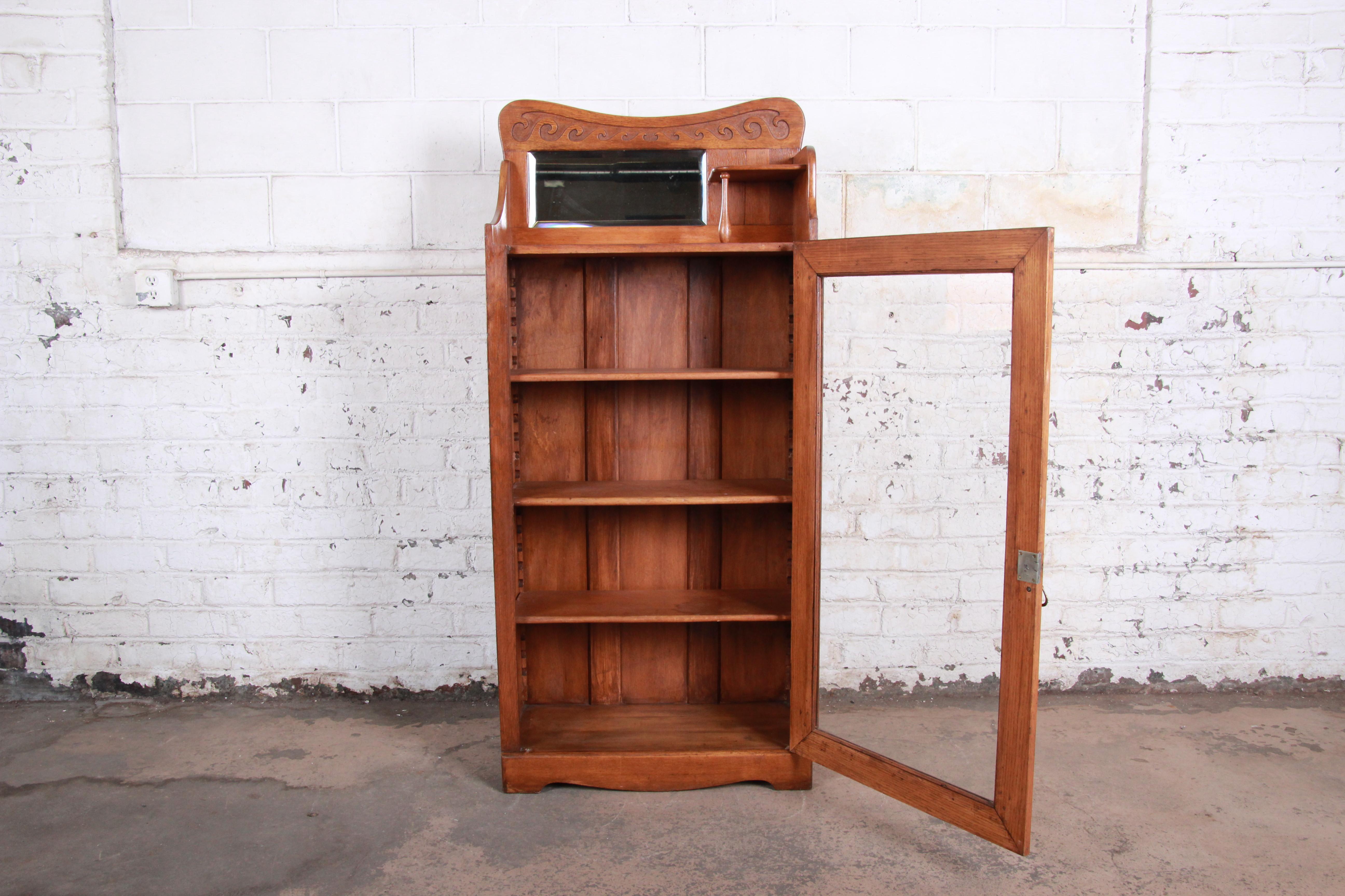 American Antique Carved Oak Glass Front Bookcase with Beveled Mirror, circa 1900