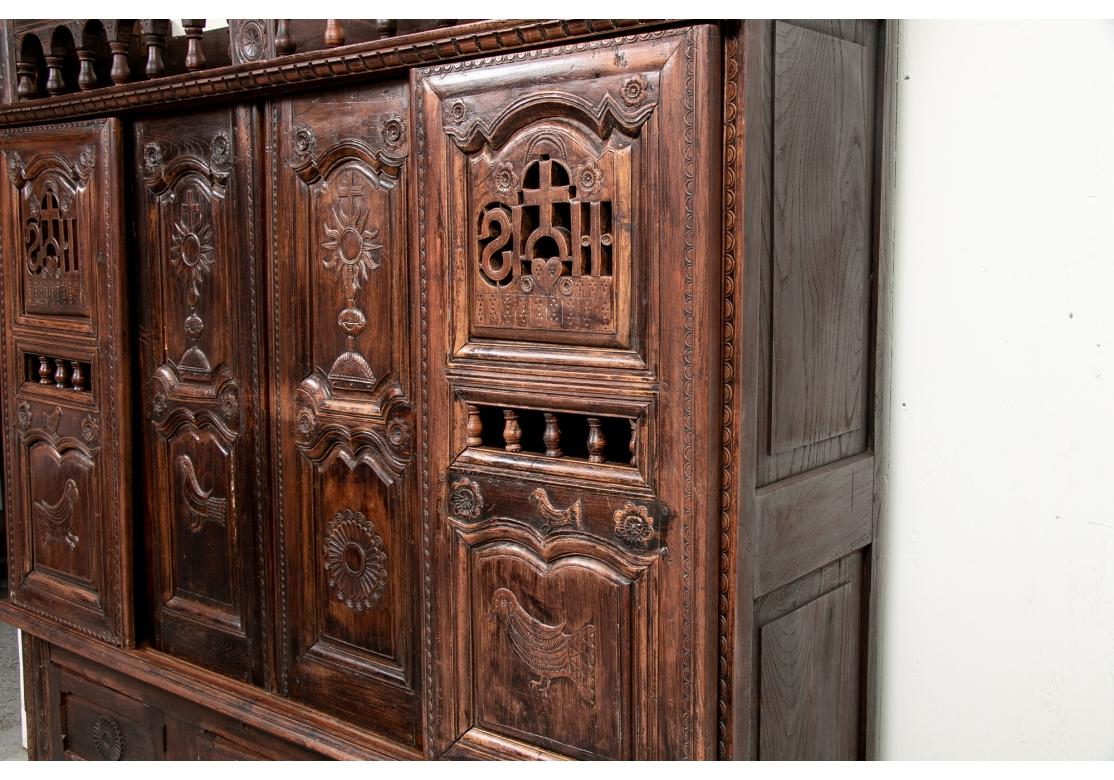 A Historic Lit Clos bed from Brittany France now in use as a Cupboard. The Lit Clos was the traditional Country French bed in use when one room served as kitchen, living room and bedroom allowing privacy. A tall cabinet with a carved cornice over a