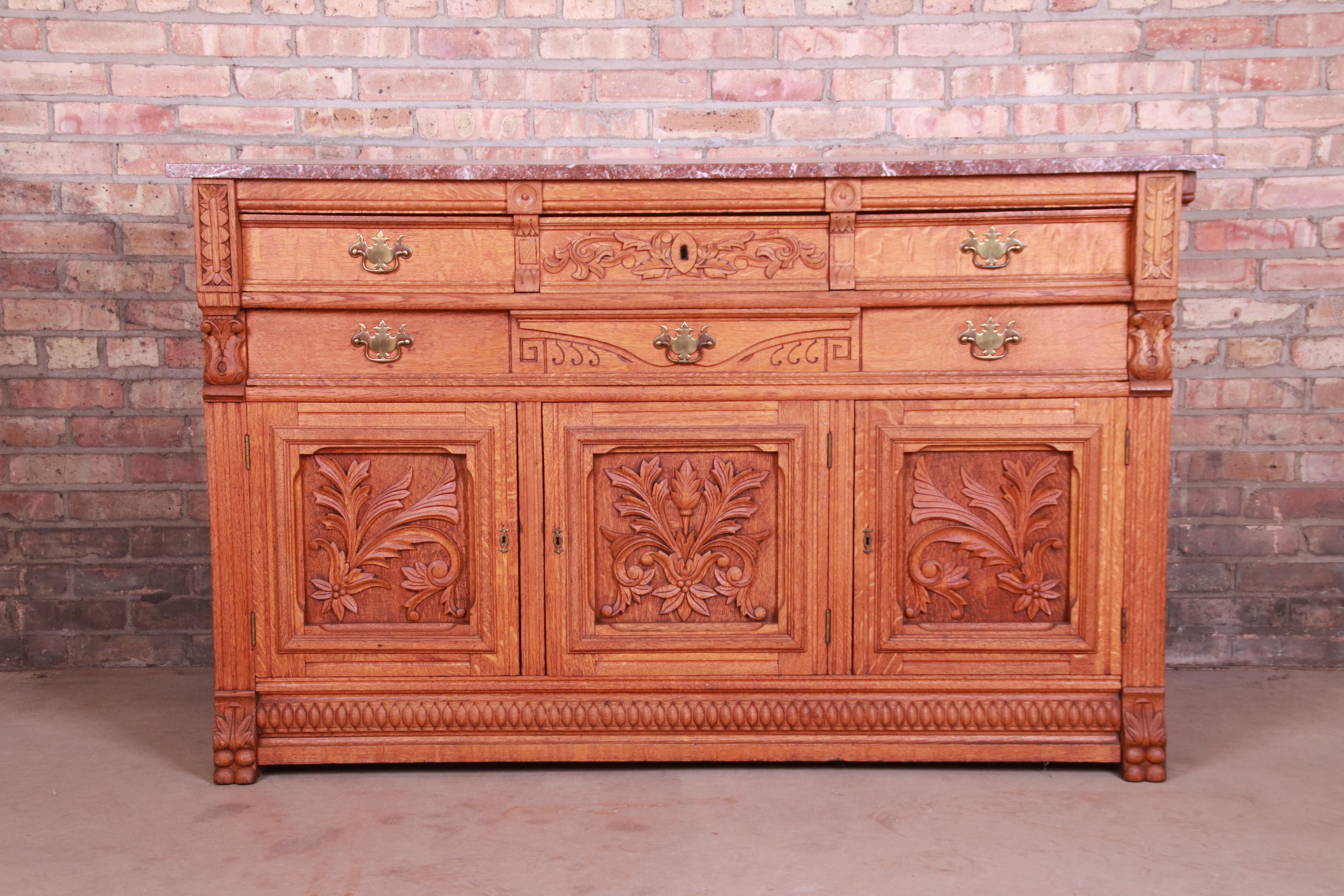 An exceptional antique ornate carved sideboard, credenza, or bar cabinet

Attributed to R.J. Horner & Co.

USA, circa 1890s

Carved solid oak, with brass hardware and marble top.

Measures: 60.25