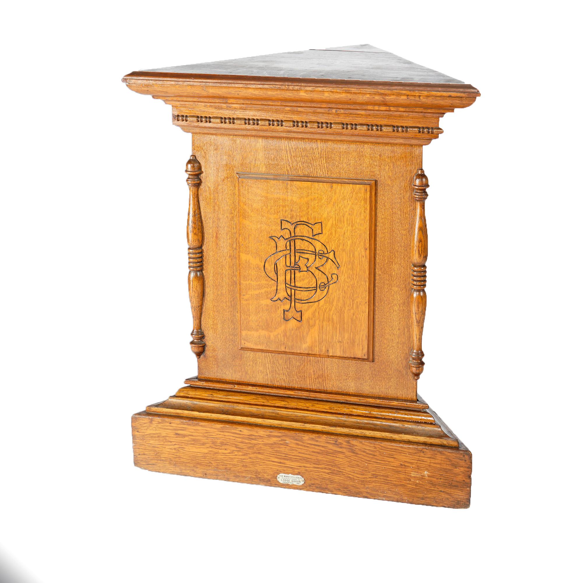 An antique Masonic pedestal by Ward-Stilson Co offers quarter sawn oak construction in triangular form with display platform over paneled and stepped base, monogrammed and maker plaque as photographed, c1900

Measures- 32''H x 22.5''W x 22.5''D;