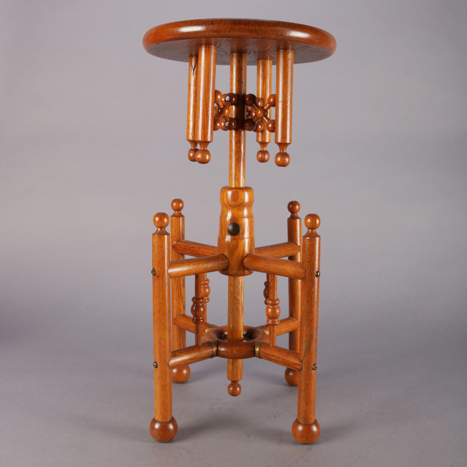 Antique piano stool features oak construction with stick and ball form and adjustable seat, circa 1880.

Measures: 27