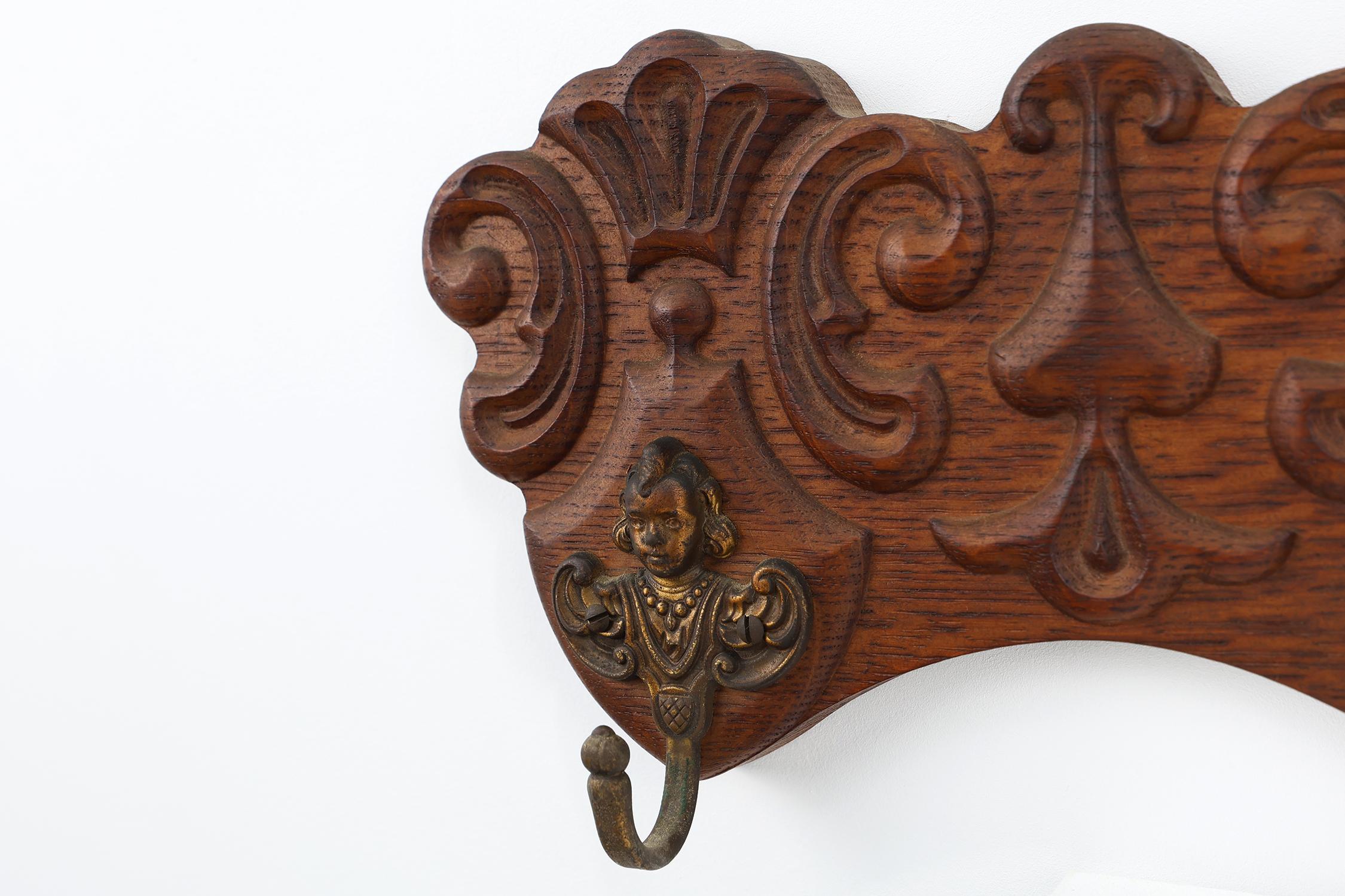 Rustic Antique Carved oak Wall mount coat rack with 3 brass angel hooks, France 1900s For Sale