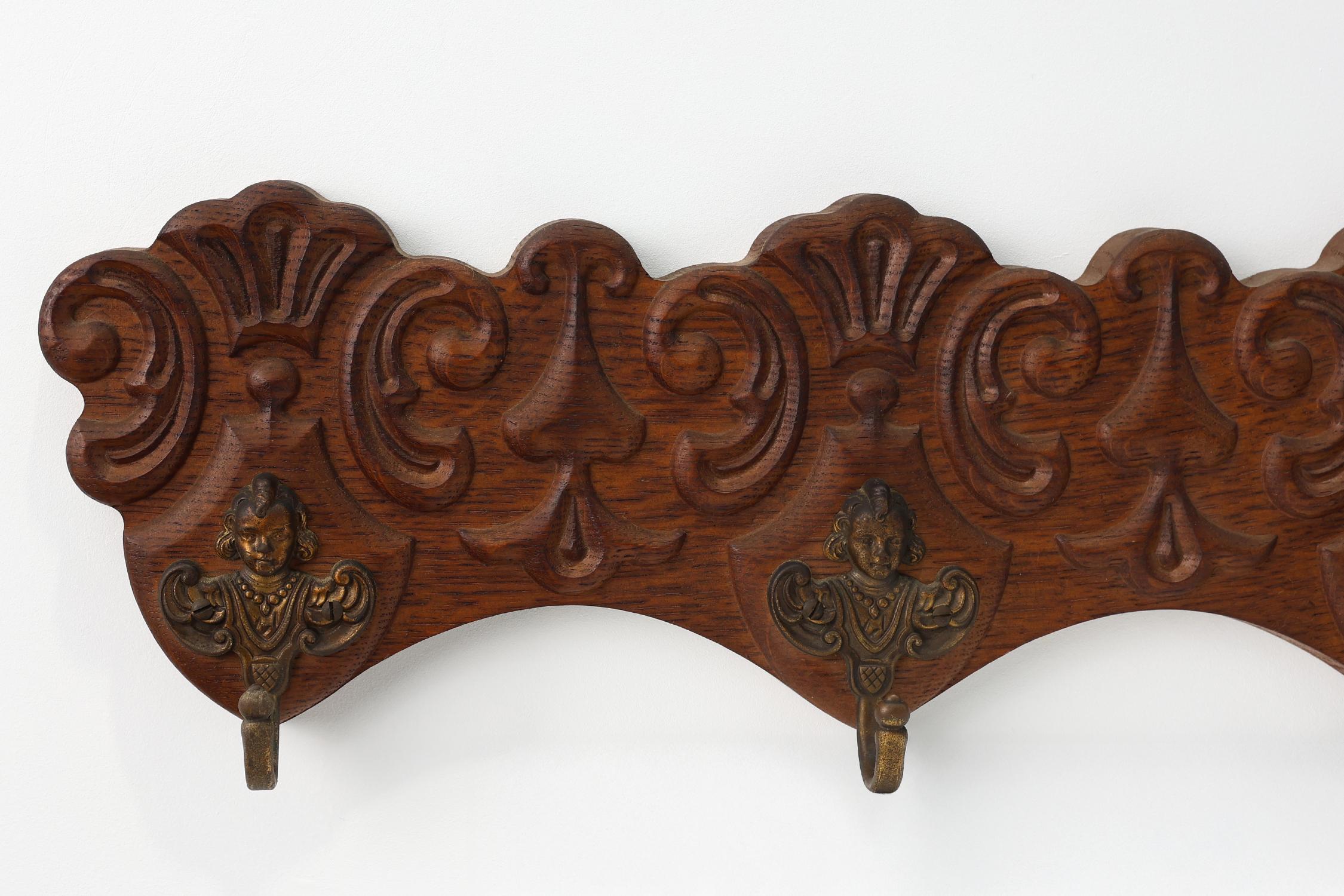 French Antique Carved oak Wall mount coat rack with 3 brass angel hooks, France 1900s For Sale