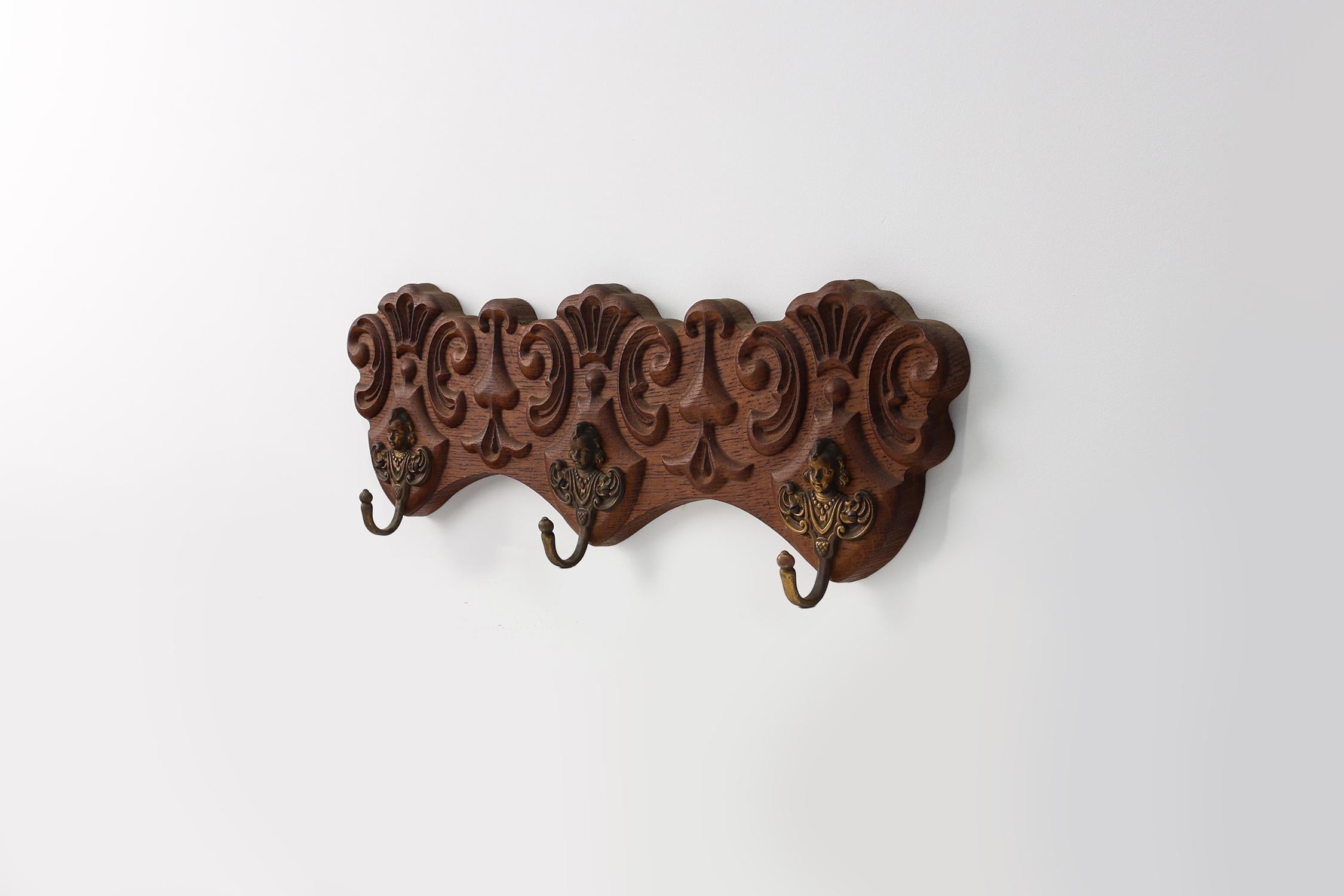 Hand-Carved Antique Carved oak Wall mount coat rack with 3 brass angel hooks, France 1900s For Sale
