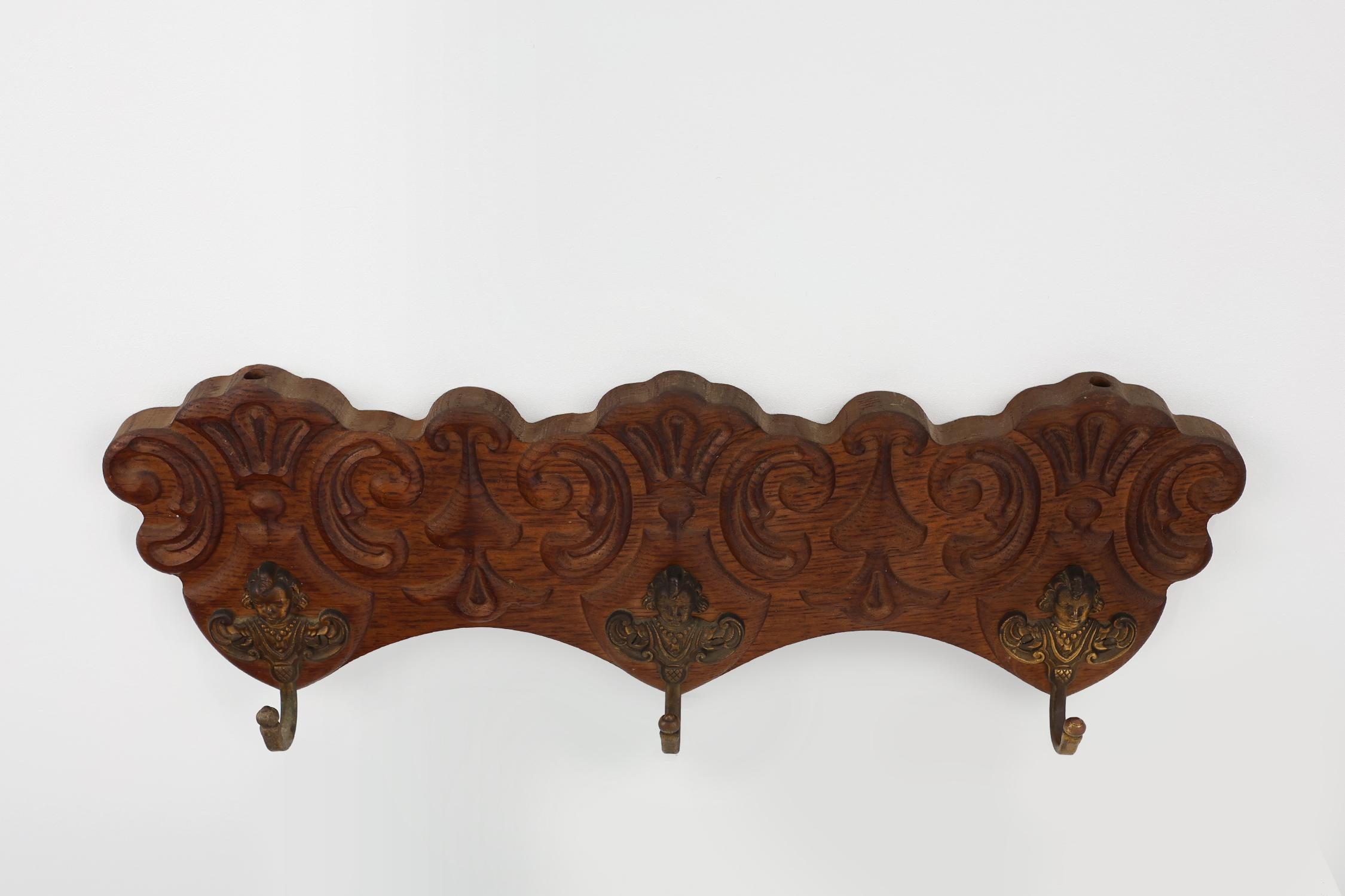 Brass Antique Carved oak Wall mount coat rack with 3 brass angel hooks, France 1900s For Sale