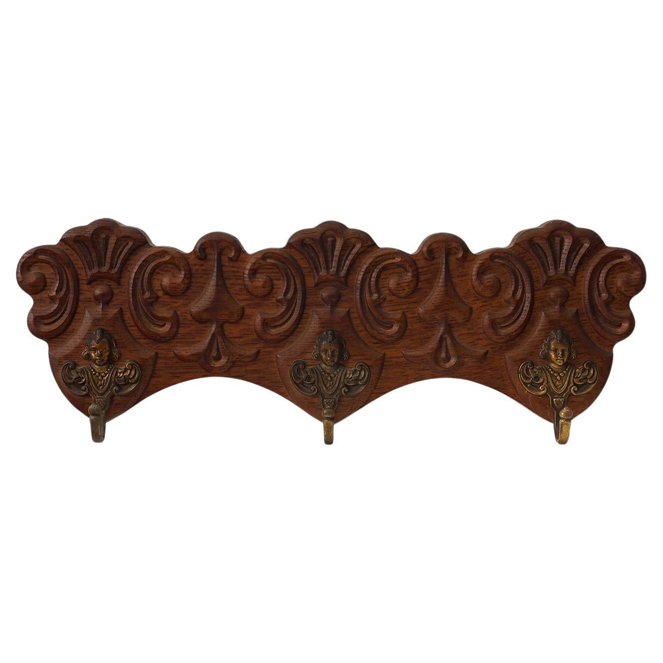Antique Carved oak Wall mount coat rack with 3 brass angel hooks, France 1900s For Sale
