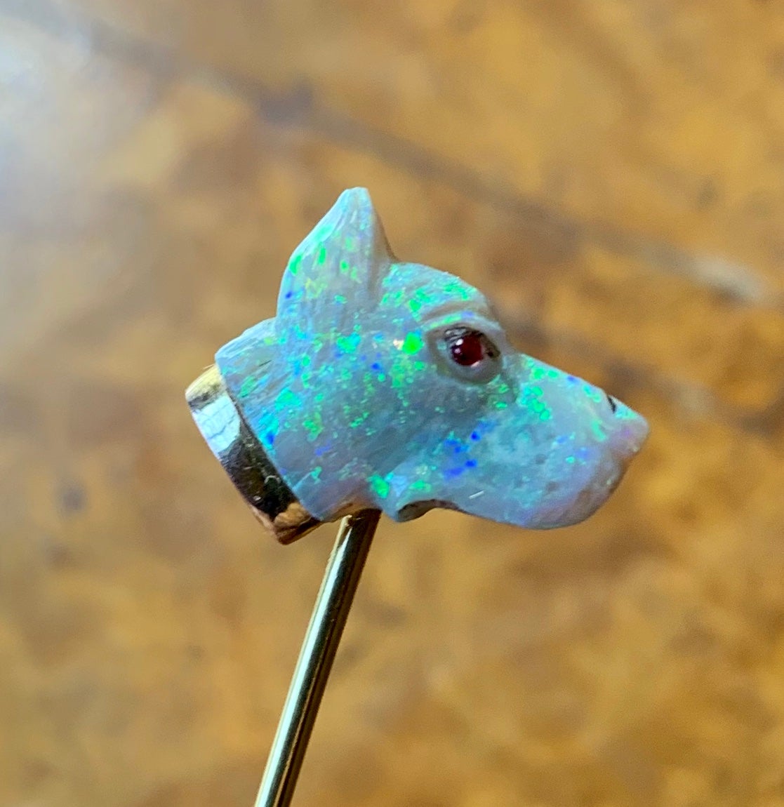 This is a gorgeous and very rare antique Victorian - Art Deco carved Opal Stickpin in the form of a Dog head with a Ruby Eye in 10-12 Karat Gold.  The stickpin is Museum Quality.  The gorgeous opal has magnificent fire with blue, green and yellow. 