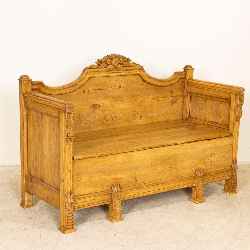 This delightful pine bench is a special find. The small size (just under 5') is unique, as most benches of the era were 5-7' long. Note the unique hand-carved feet and decorative flowers along the center back which added to the cost as it was likely