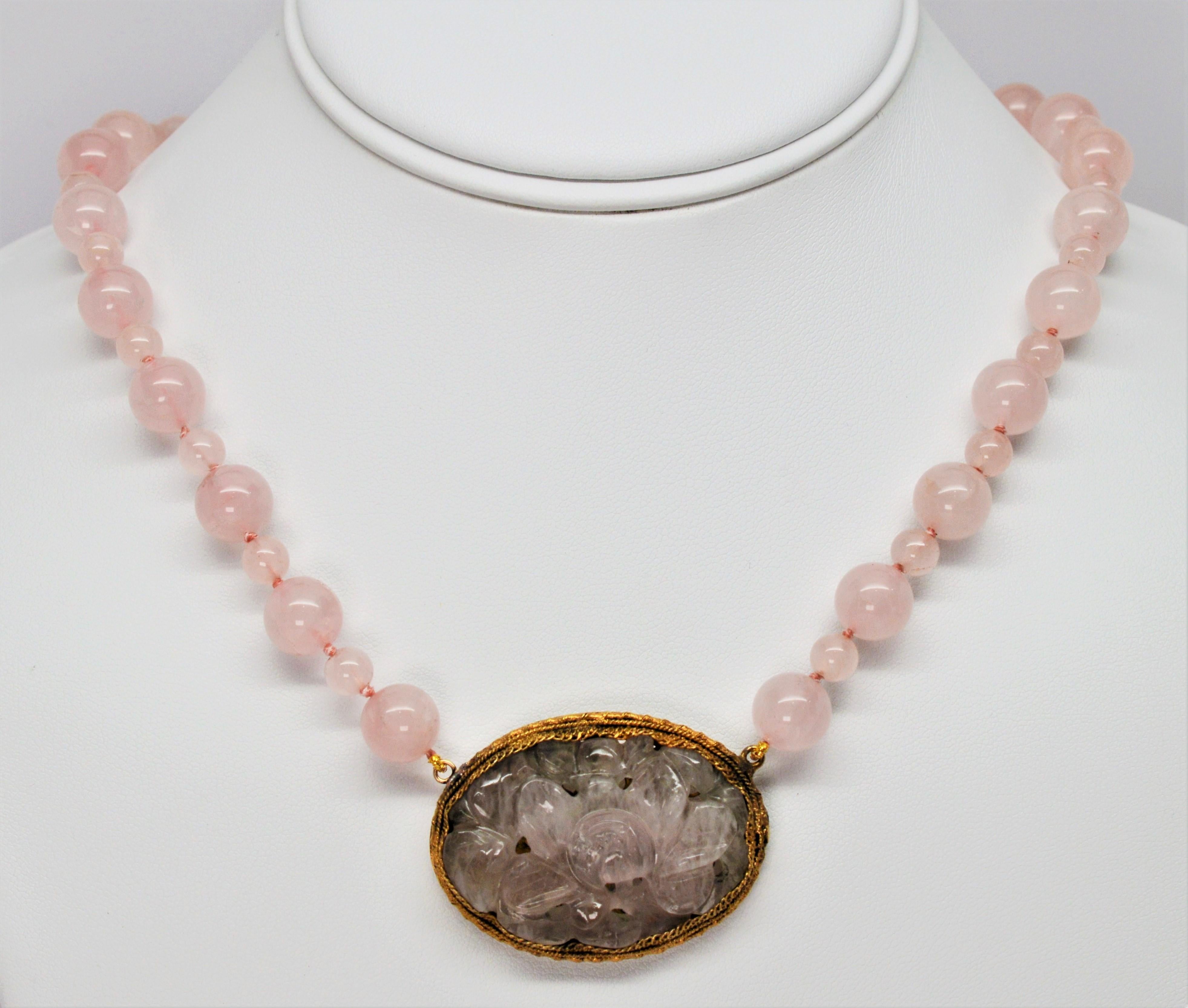 A hand carved pink quartz pendant with floral interpretations set in an decorative antique gold plated oval frame is the feature of this romantic heirloom piece. Pleasing pink quartz beads of alternating size, 10mm and 6mm create this 24 inch hand