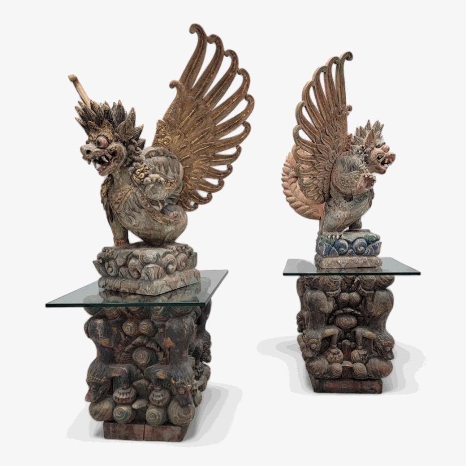 Antique Hand Carved Polychromed Balinese Garuda Statues on Glass Top Side-Table/Pedestals - Set of 2

This fantastic set of hand-carved polychromed wood statues would be stunning accents to flank a stately doorway. They are Balinese representations