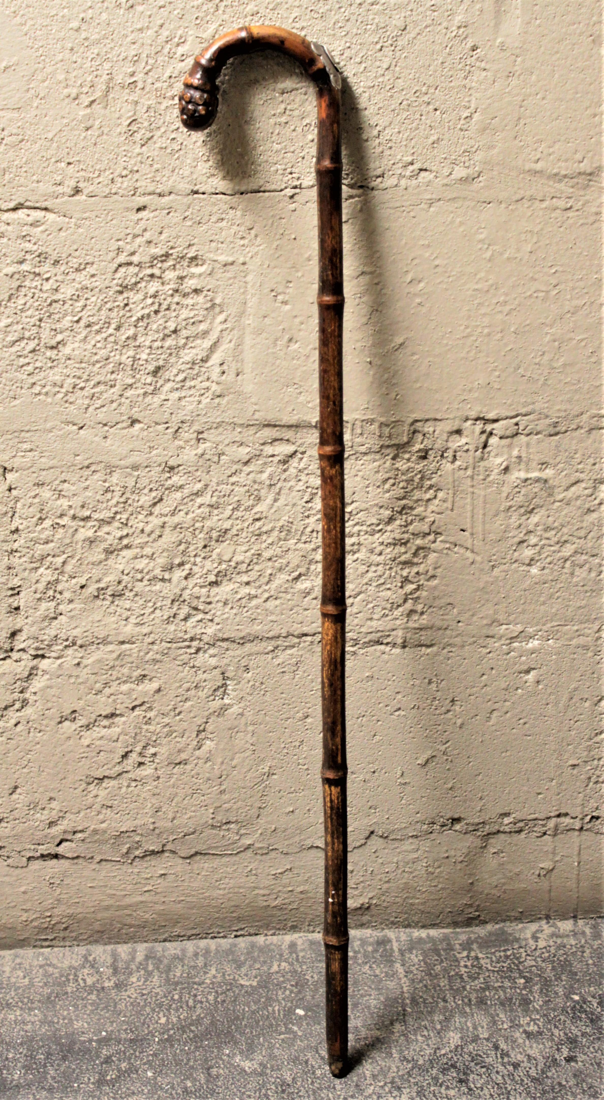 This antique horse dealer's cane was made in England by most likely Joseph Hicks and dates to the 1890s and done in the period, high Victorian style. The cane handle is a carved root ball, and inserted within the body of the cane is a well-crafted