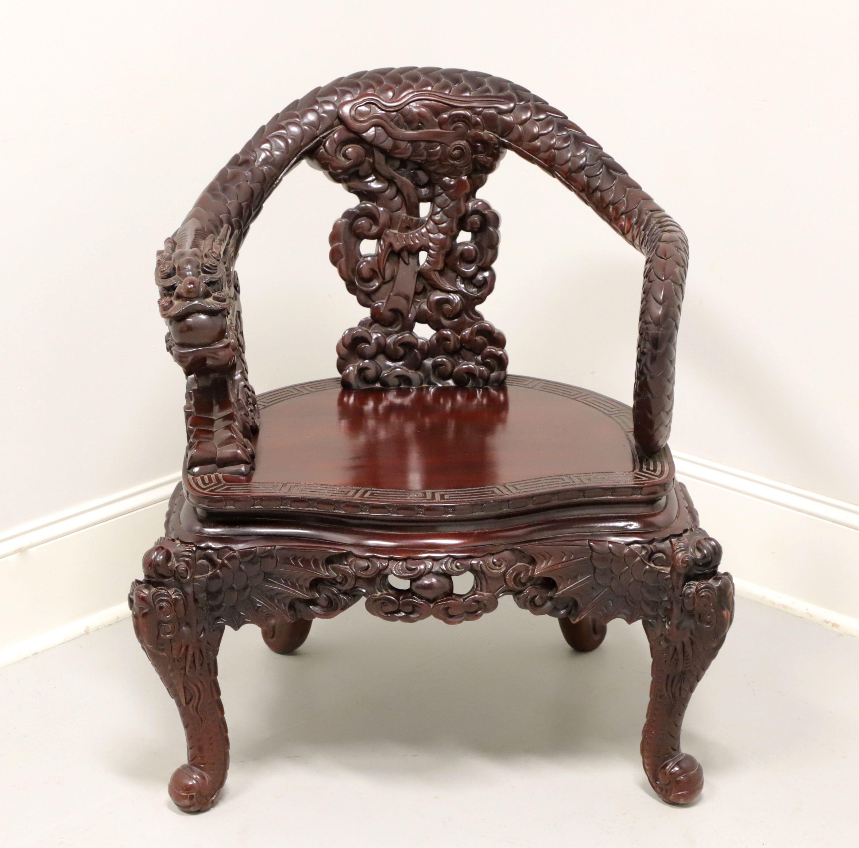 An antique Asian Japanese style Meiji Period dragon armchair, unbranded. Solid rosewood, hand carved with arms, crestrail & stiles in the form of a dragon, carved edge to smooth seat, elaborately carved backrest, apron & knees, and serpent paw feet.