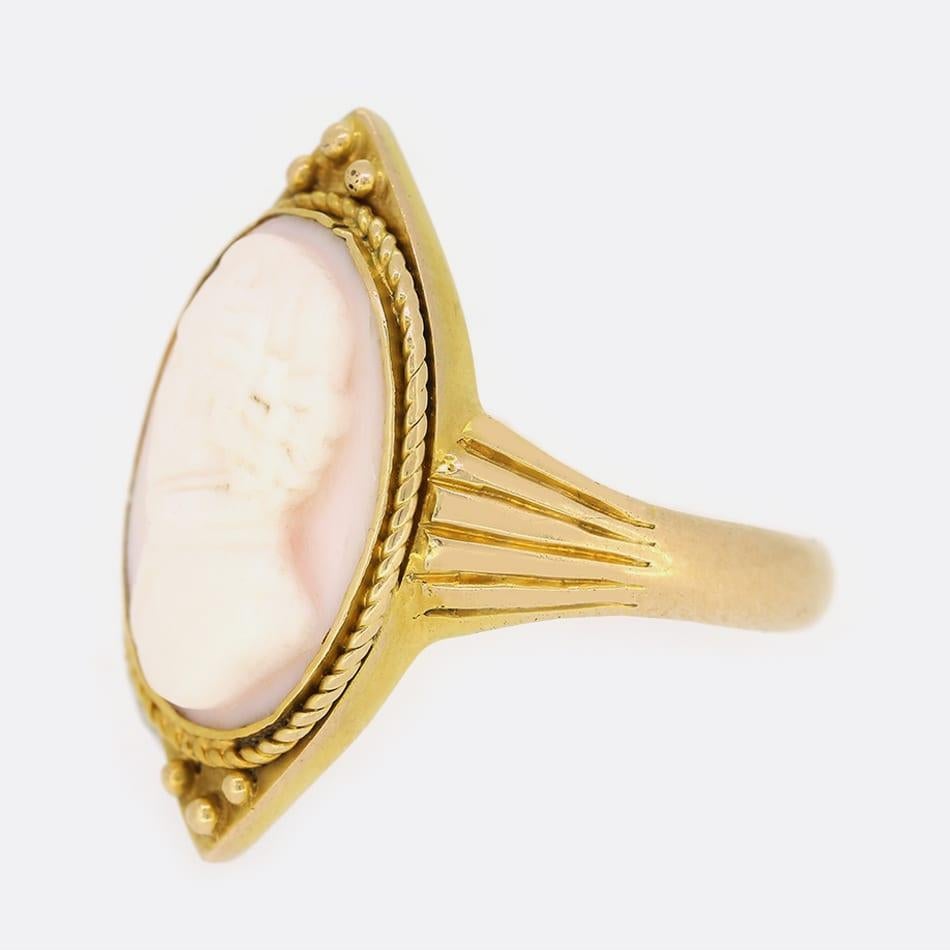This shell cameo ring is carved superbly and executed with high relief workmanship, depicting a lovely profile of a gentleman turning to his left. The ring has been crafted in 15ct yellow gold in a marquise shape with split style
