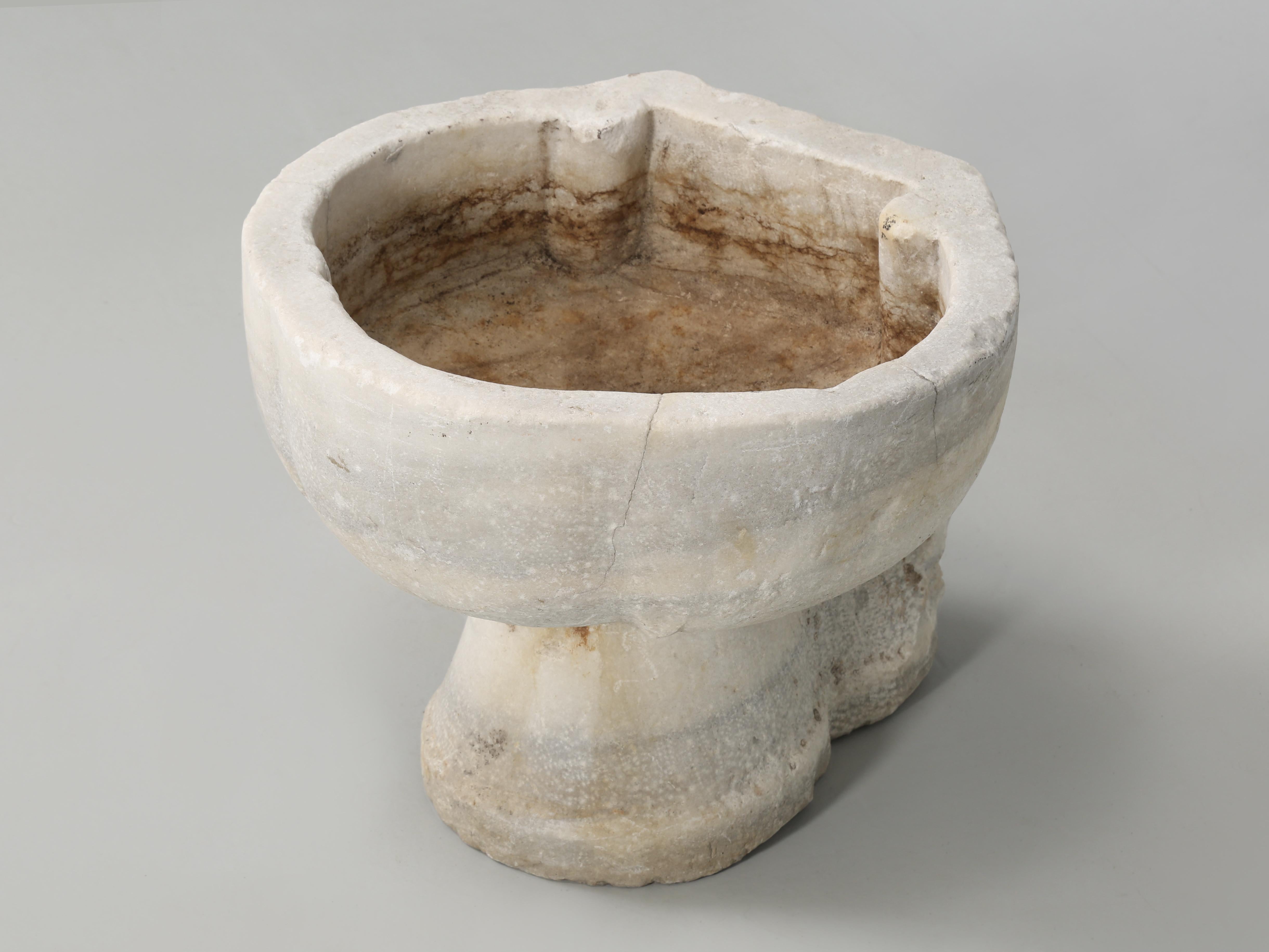 Although this may look like a holy water font from an ancient Italian church, we believe it’s probably a marble wash basin, or sink based on the fact that it has an old drain hole. You can clearly see that the marble sink was mounted into a wall and