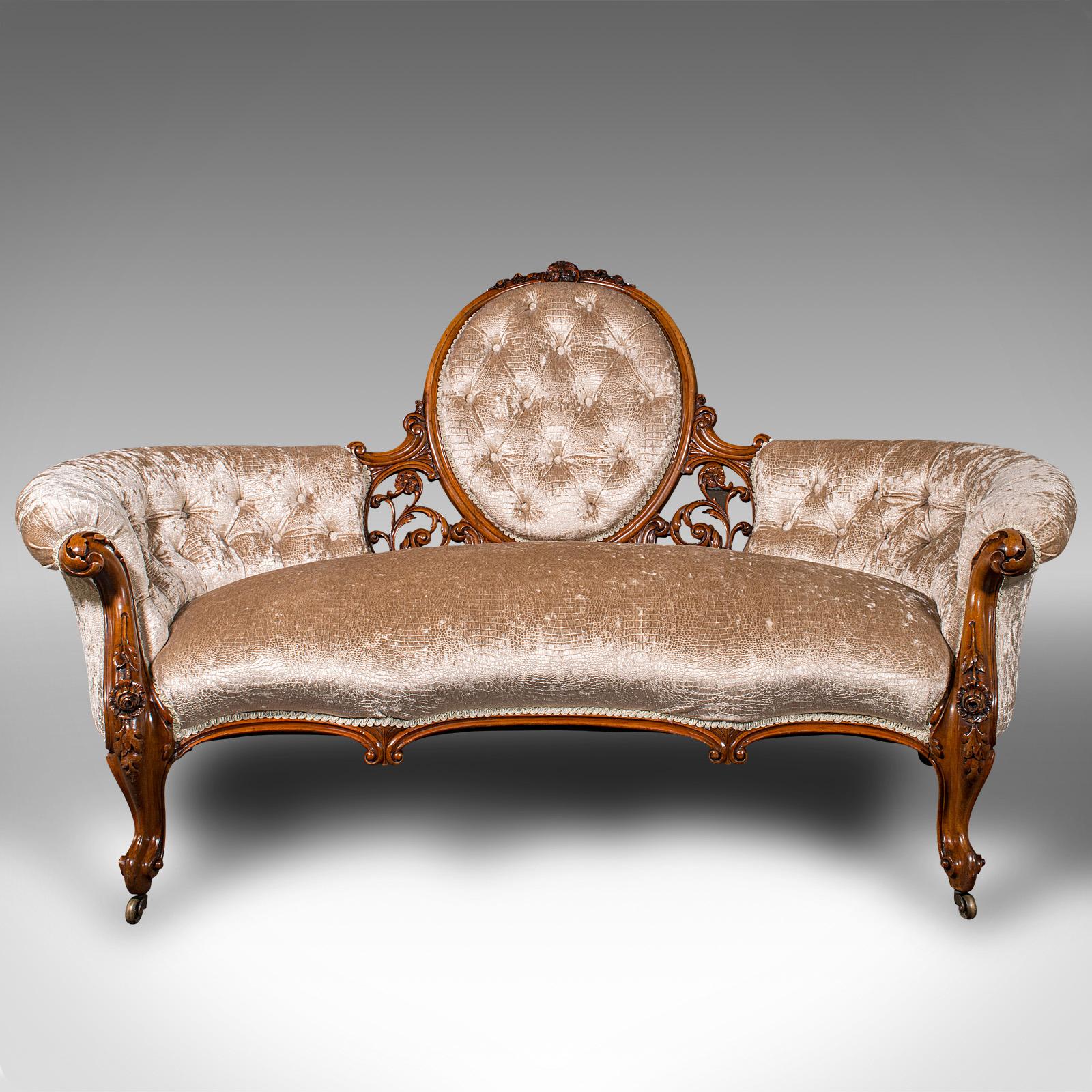 
This is an antique carved spoon back settee. An English, walnut and Chenille upholstered showpiece sofa, dating to the early Victorian period, circa 1840.

Alluring, inviting and exquisite - a sofa of exceptional visual appeal
Displays a desirable