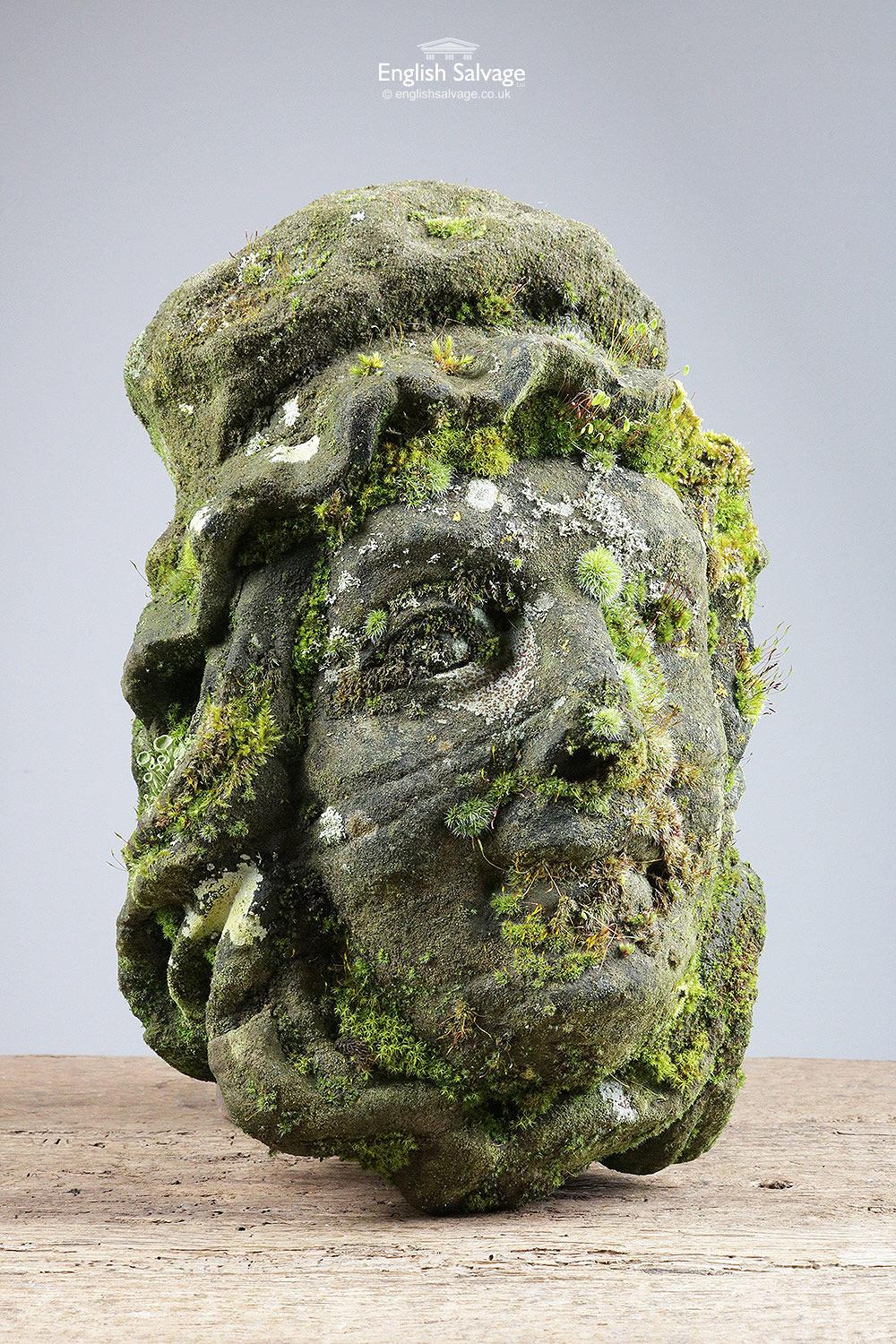 Very old antique carved stone head of a woman wearing a bonnet. Measurements given below are the approximate maximum overall. The back is fairly flat so could be wall-mounted. Highly weathered and mossy.