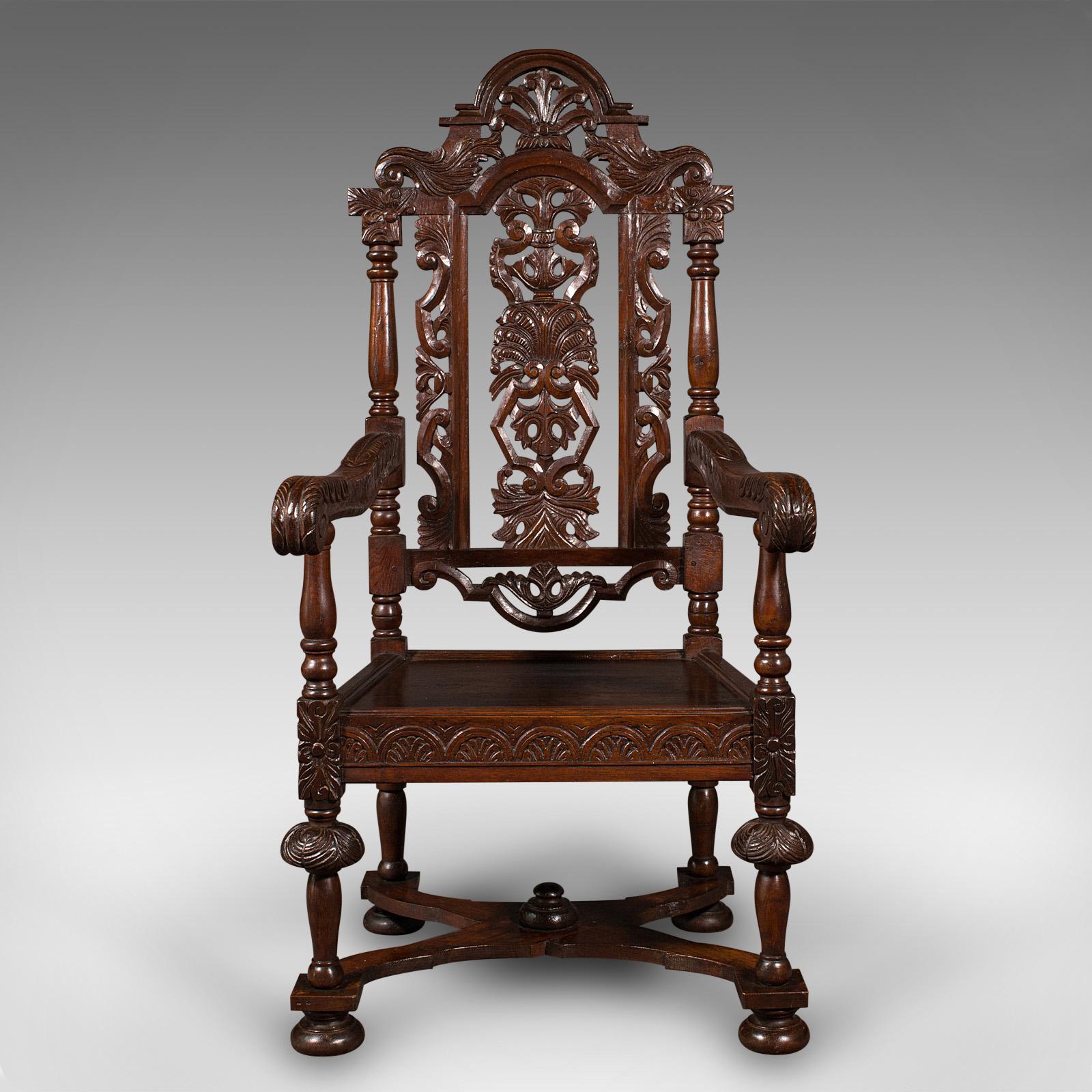 This is an antique carved throne chair. A Scottish, oak carver elbow chair with Gothic Revival taste, dating to the Victorian period, circa 1890.

Delightfully carved chair, with distinguished Gothic motif throughout
Displays a desirable aged