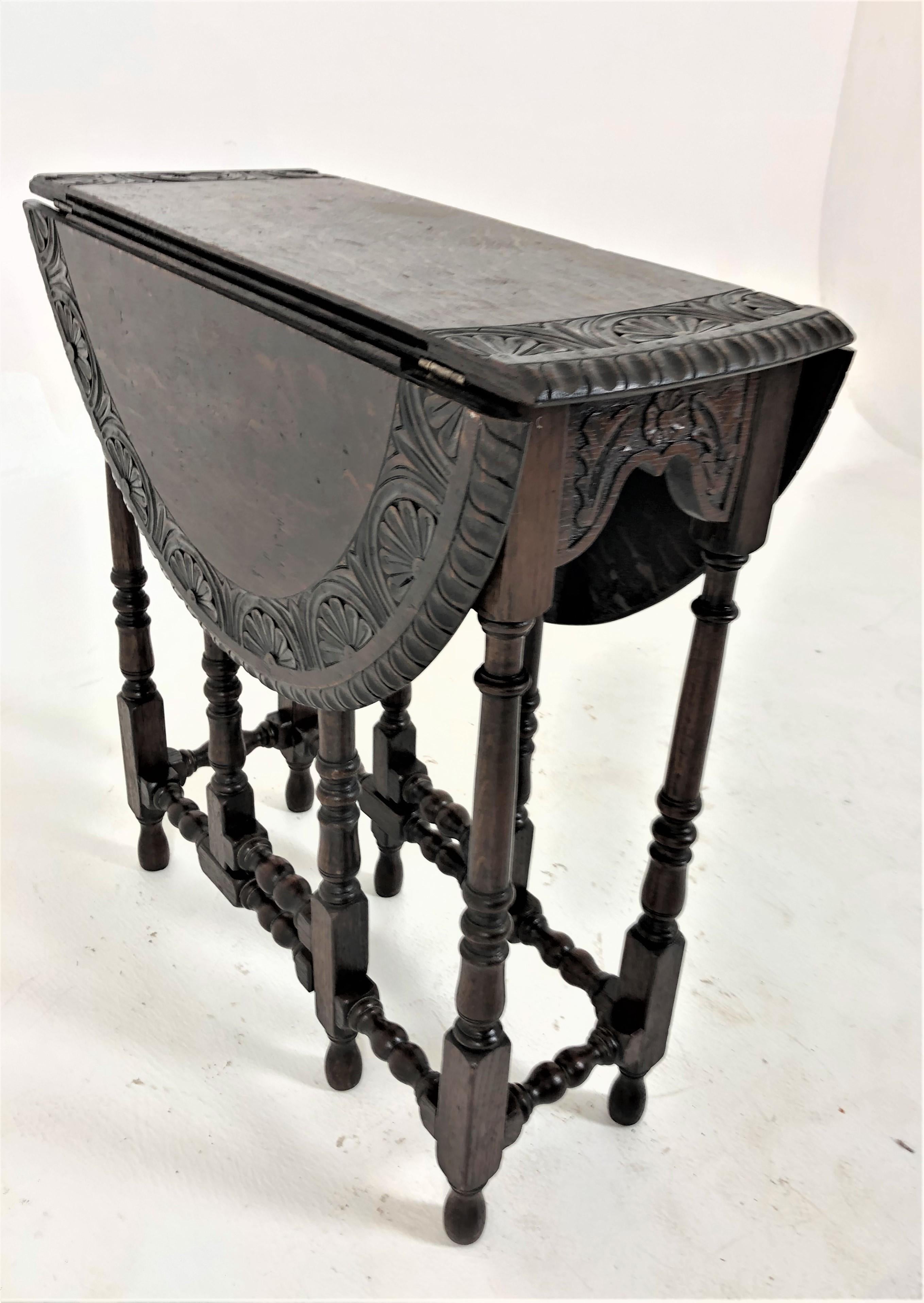 Antique carved tiger oak drop leaf, gateleg table, Scotland 1910, H843

Scotland 1910.
Solid oak.
Original finish.
Carved oak drop leaf table has an oval top.
With carved detail and a scalloped edge.
All supported by turned legs and stretchers