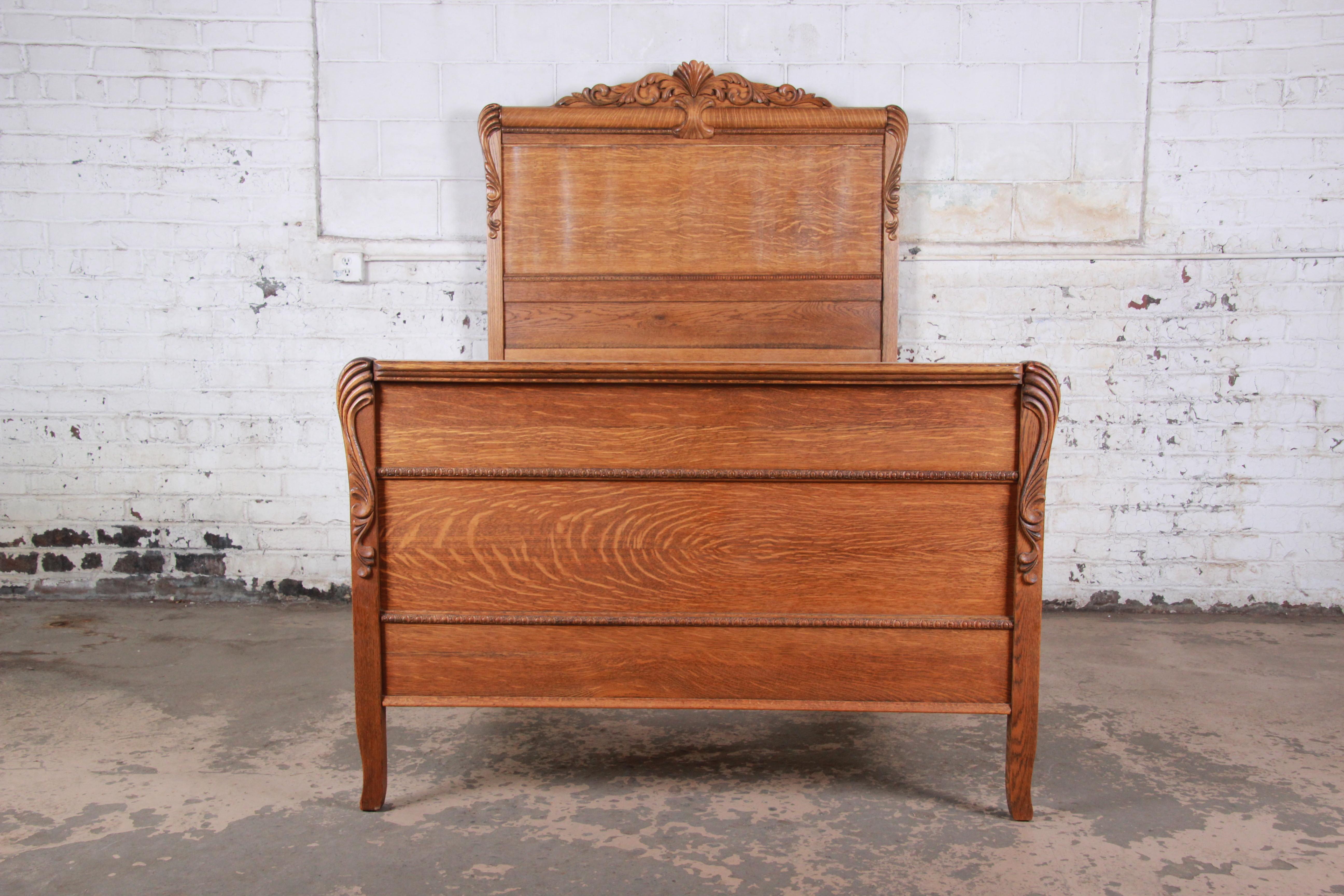 A gorgeous antique carved tiger oak full size bed frame

USA, circa 1900

Measures: 58.5