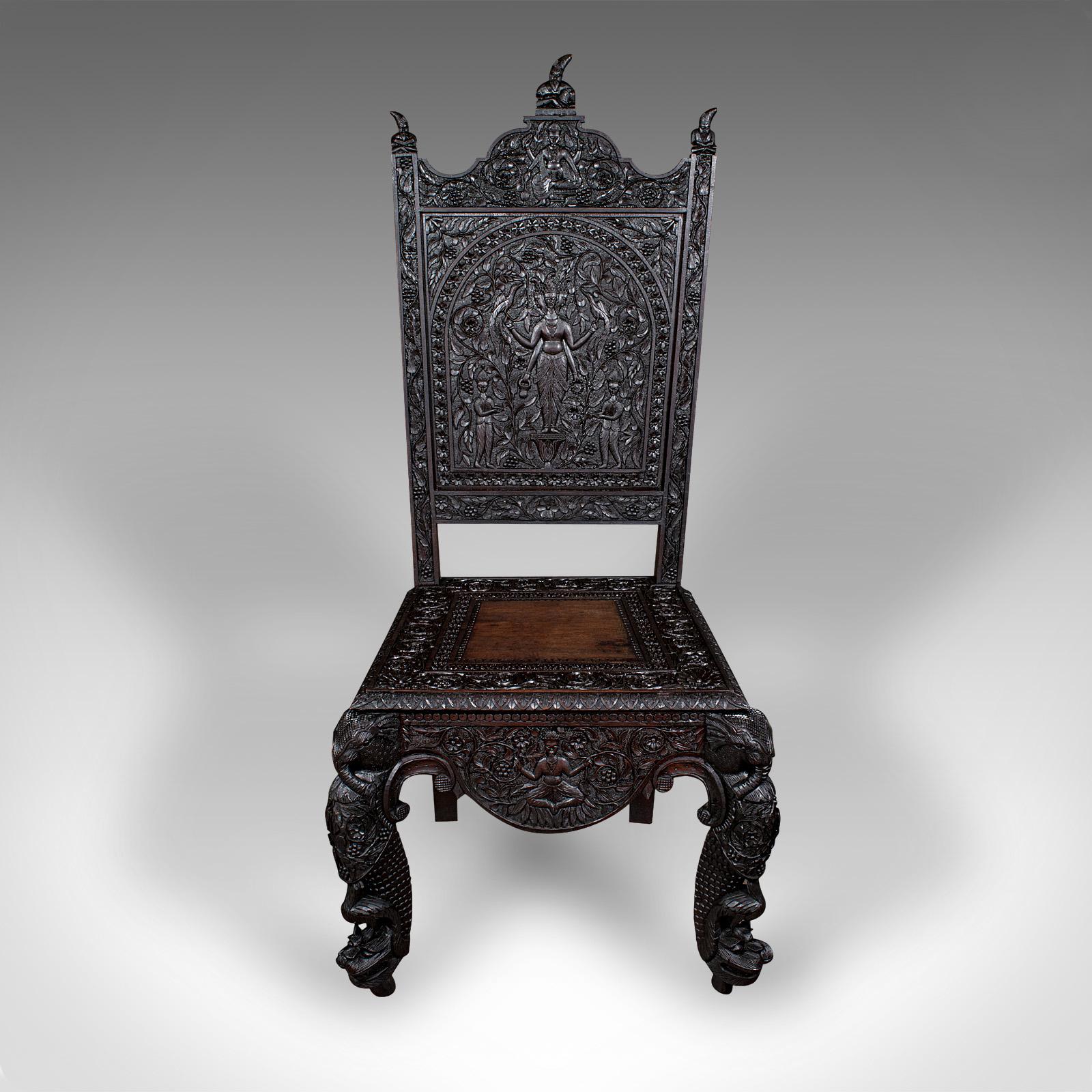 This is an antique carved veranda chair. A Ceylonese, solid teak ornate seat, dating to the Victorian period, circa 1880.

Exceptional craftsmanship to this superb showpiece chair
Displaying a desirable aged patina and in good order
