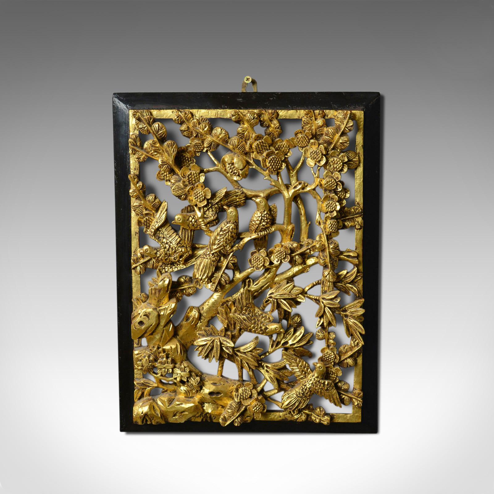 This is an antique carved wall panel. A Chinese, giltwood decorative panel dating to the turn of the 20th century, circa 1900.

Profusely carved demonstrating exceptional skill
Created from a single wooden slab
Abundant interest from every