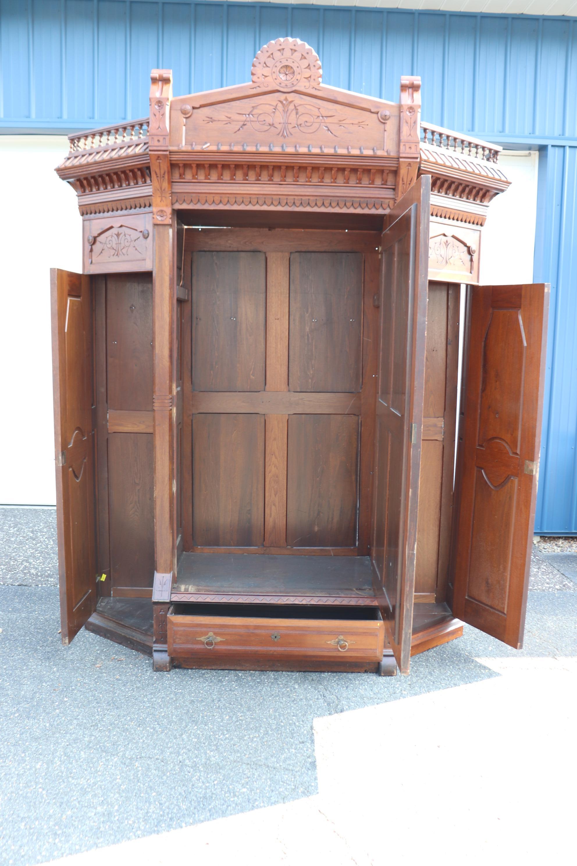 This is a superb carved walnut Renaissance Revival Victorian era armoire of extraordinary design and scale. The carving and design are unmistakably done by Daniel Pabst in our opinion and reflect the clean lines this German craftsman brought to