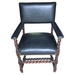 Fauteuil ancien en noyer sculpté et simili cuir noir Barley Twist 