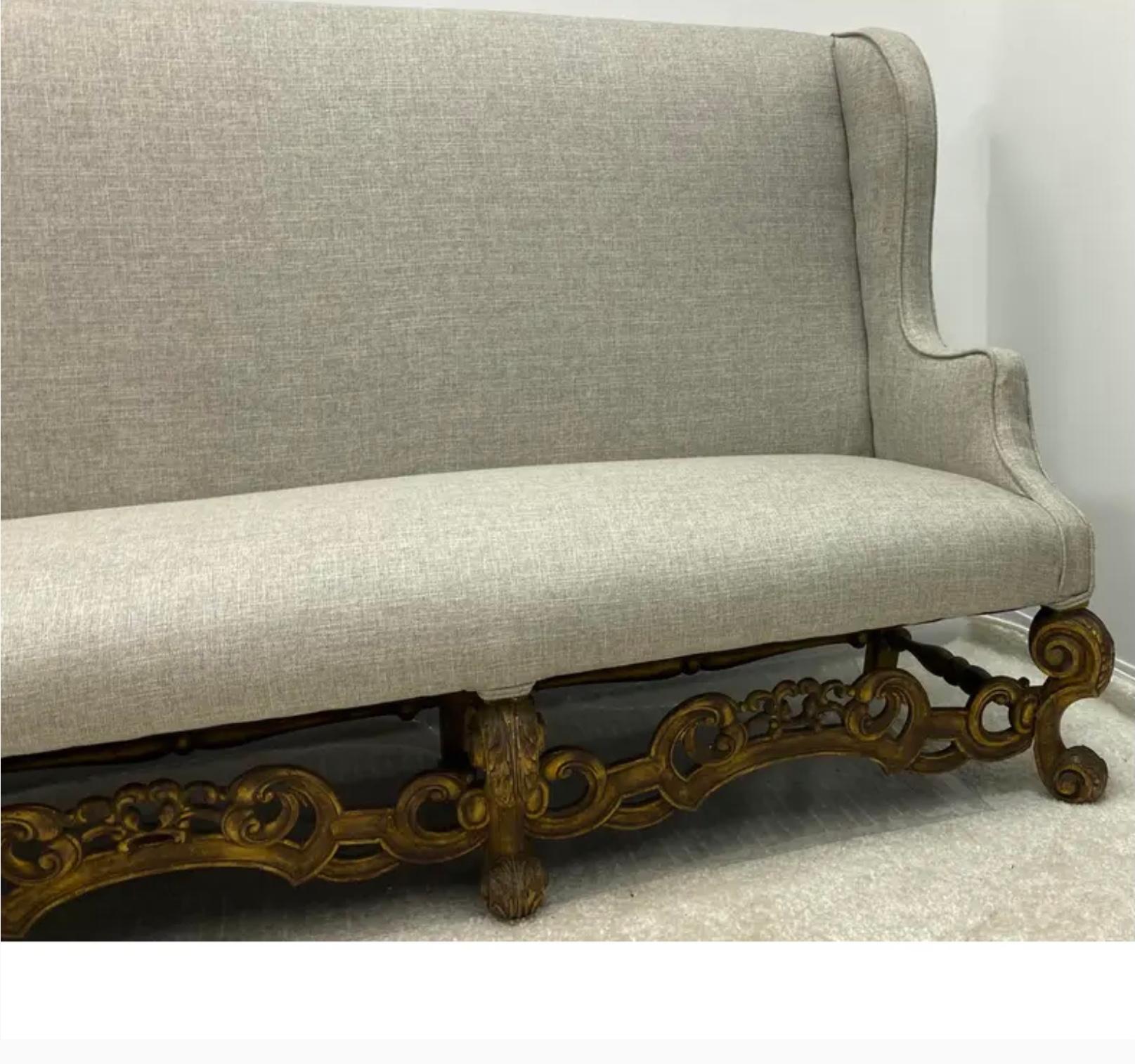 This is a wonderful antique French sofa newly re-done in gray linen with a coordinating textured linen on the back. The carved stretcher and feet are walnut.