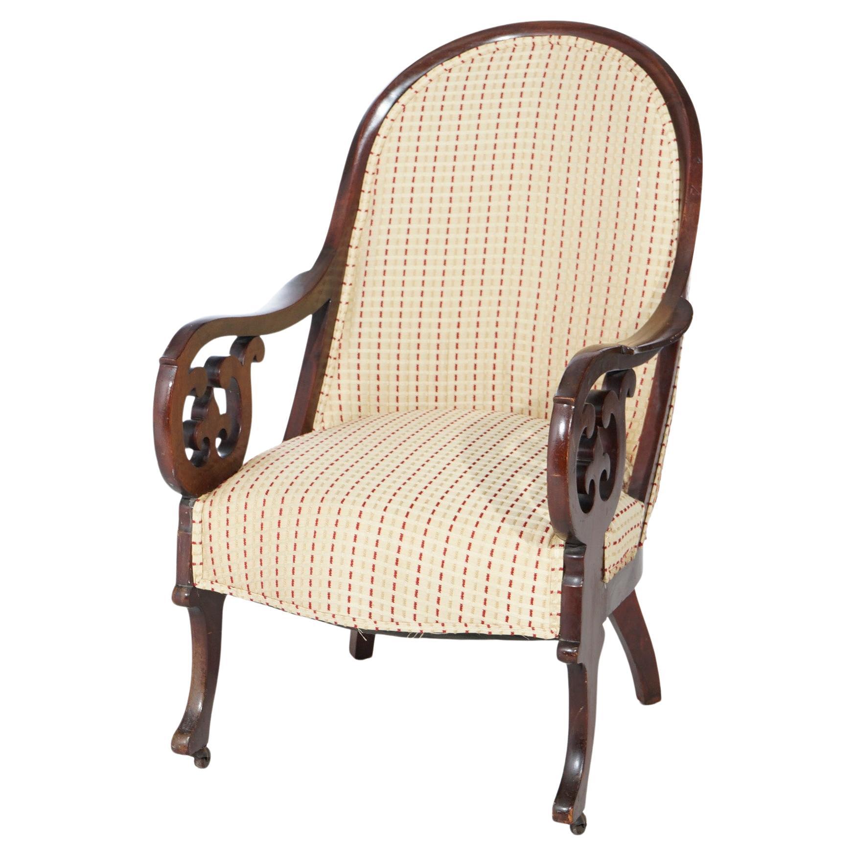 An antique Lincoln arm chair offers carved walnut frame with upholstered back and seat, carved scroll form arms with fleur de lis elements, c1880.

Measures- 38.5''H x 24.75''W x 31''D.