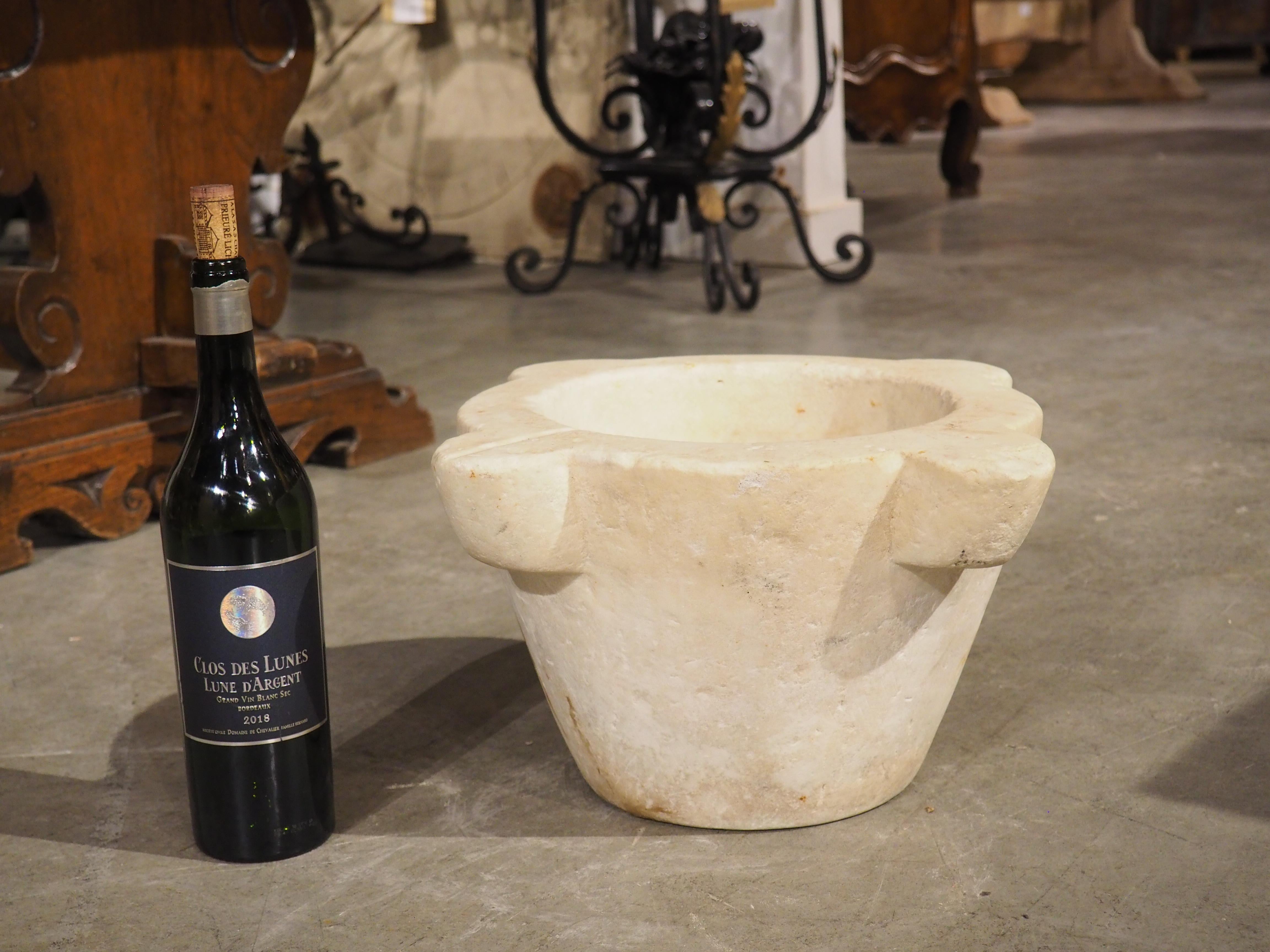 This very old hand-carved marble mortar dates to circa 1800 and originally came from France. The original use of a mortar (when paired with a pestle) was to aid pharmacists in crushing herbs into powder for medicinal purposes. In France, they were