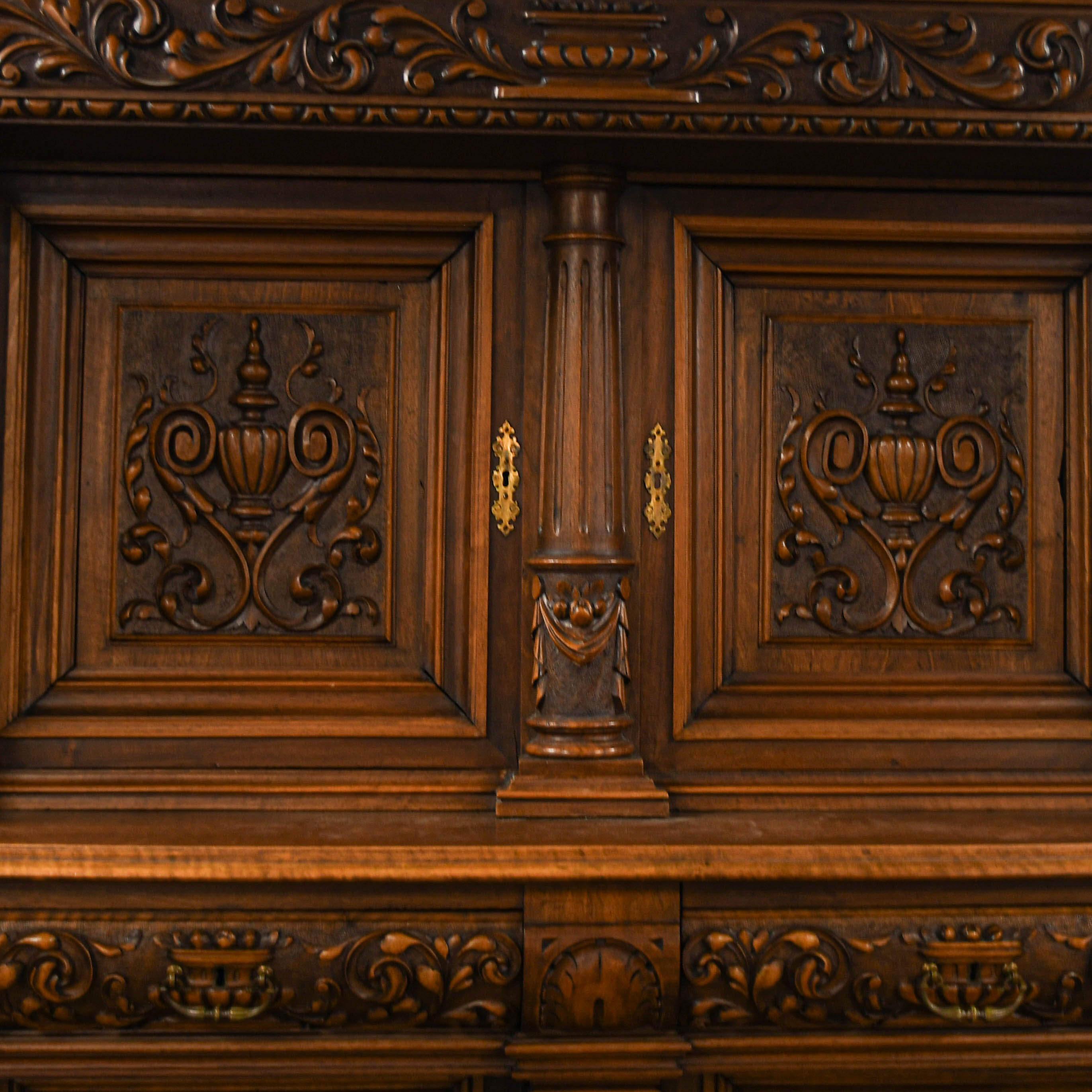 Step into old-world grandeur with this masterfully crafted antique carved wood cabinet. Towering with architectural grace, this piece is a statement. Hand-carved columns, floral motifs, and intricate reliefs speak to the artistry of a bygone era,