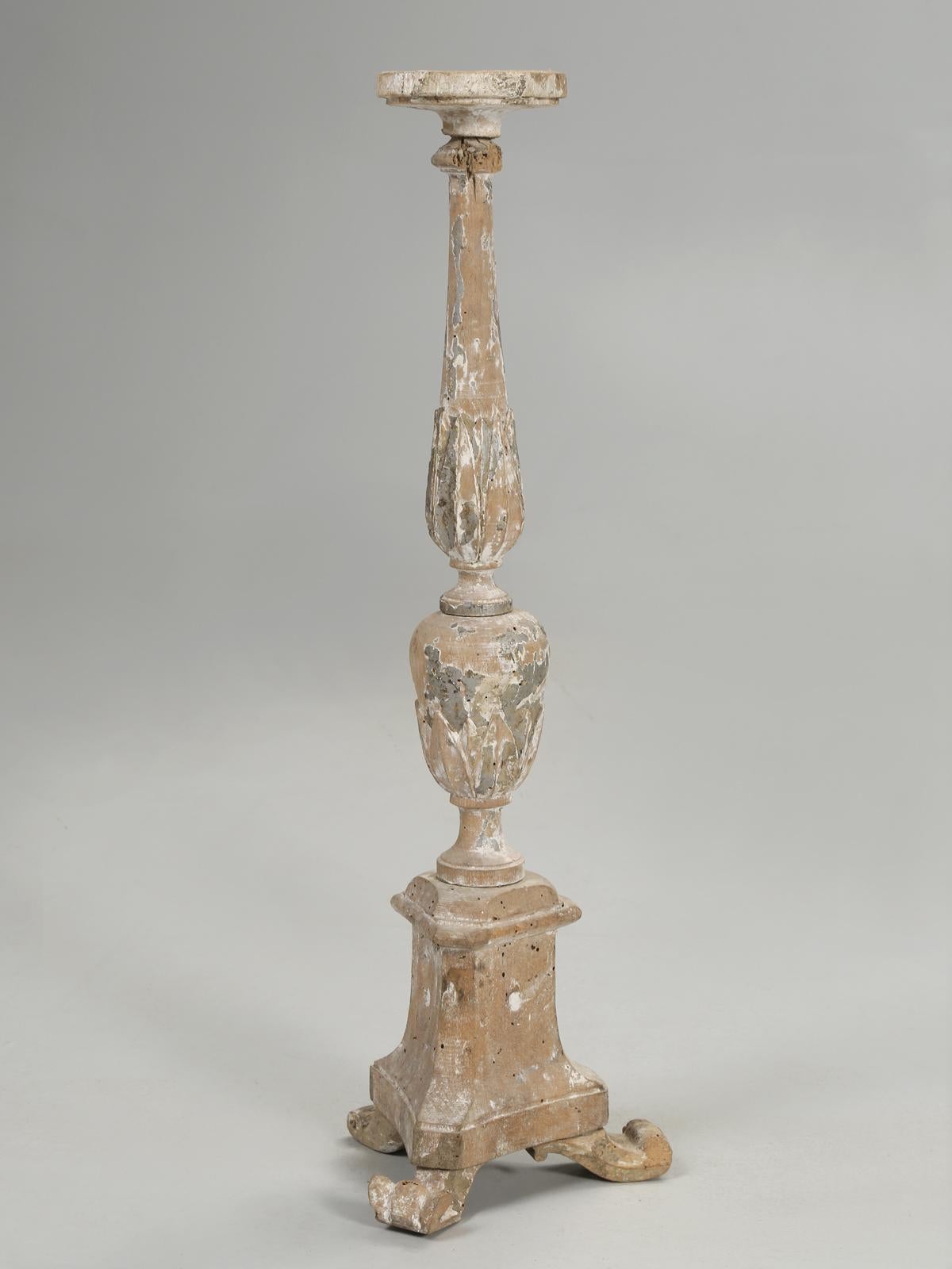 Antique 18th century Italian painted and carved wood candlestick, with a few hints of gilding still remaining. There are small patches of the original putty grey paint and the underlying white gesso showing, along with other areas on the candlestick