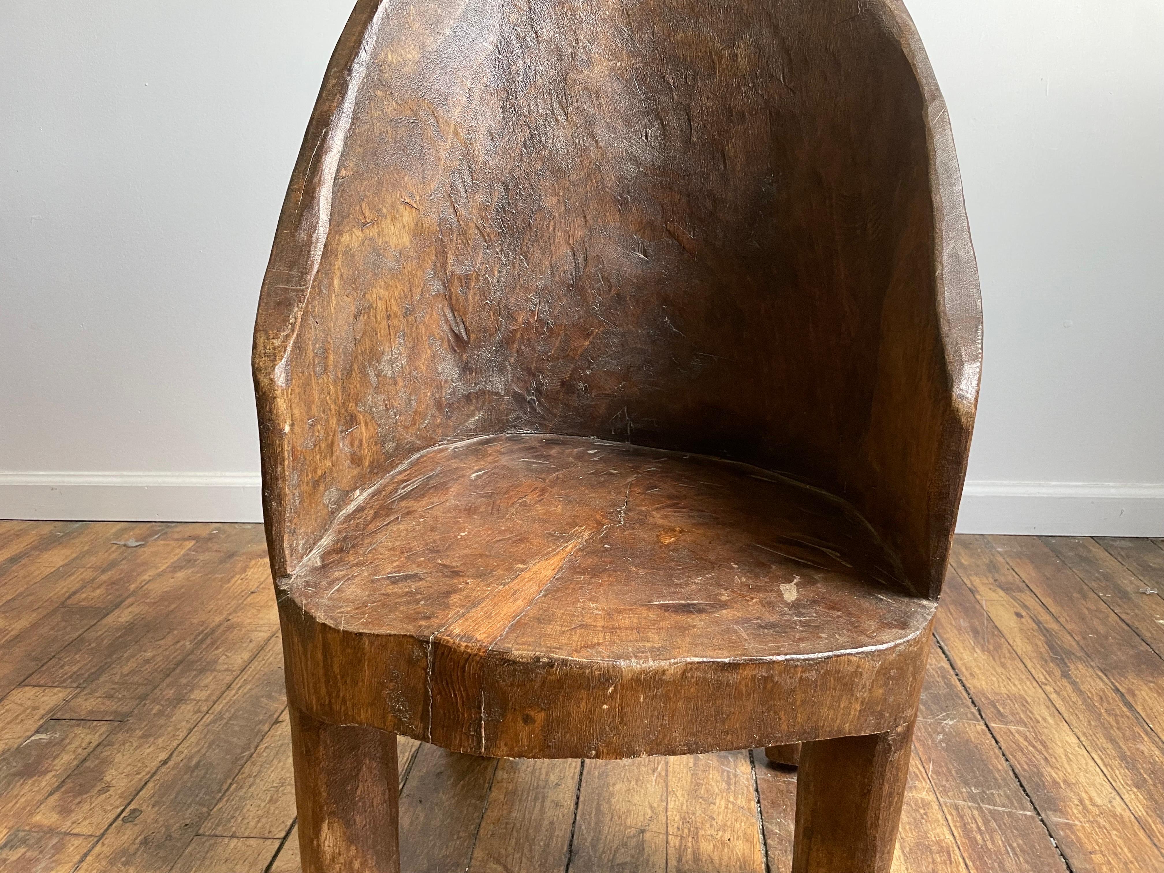 Belle chaise en bois massif sculpté avec une assise basse. 

