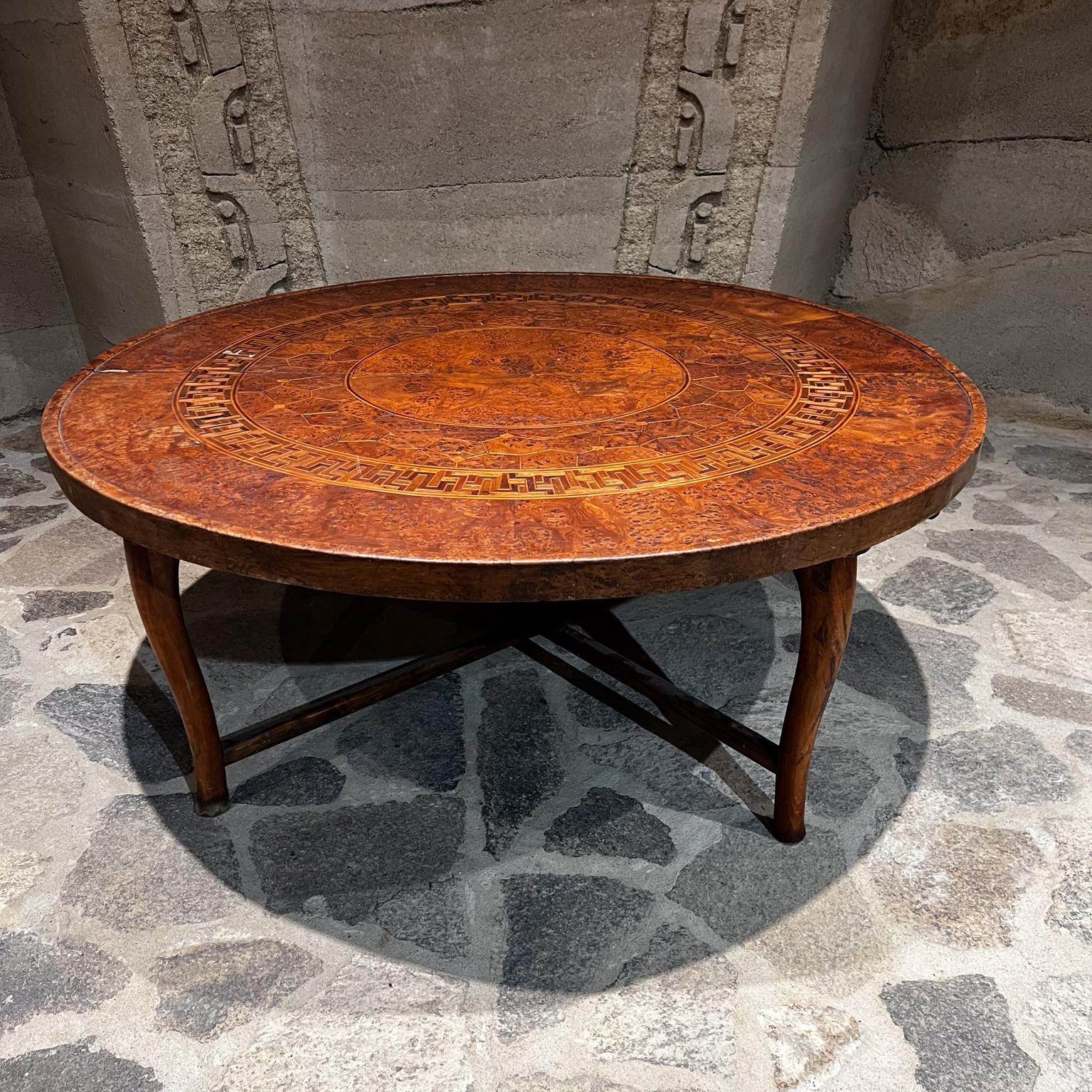 Antique Carved Wood Exotic Moroccan Coffee Table
Solid Burl Wood, Walnut and Exotic Hardwoods
Sculptural Legs and Base.
Geometric Mosaic Detail
Removable and collapsible.
20 h x 49.5 diameter
Original Unrestored Preowned Condition.
Expect vintage