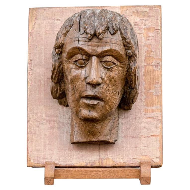 Antique Carved Wood Head Of A Male Mounted On Panel For Sale