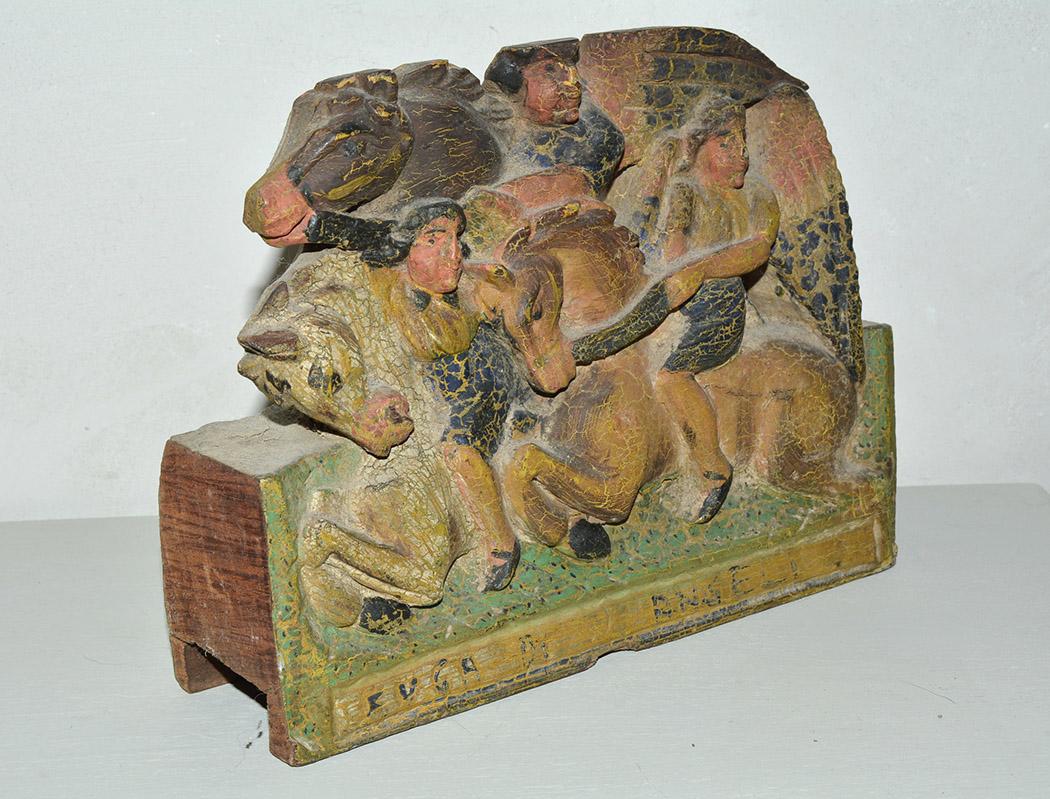 Wonderfully charming early 19th century Sicilian donkey cart fragment depicting archangels on horseback. The wood fragment is completely hand carved out of one solid piece of hardwood with hand painted features. It is painted on both sides - front