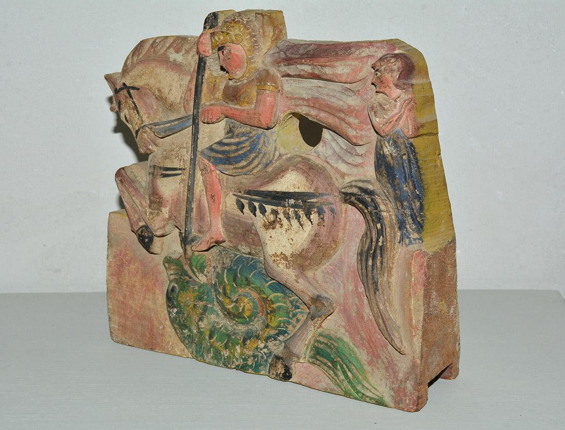 Wonderfully charming early 19th century Sicilian donkey cart fragment depicting a warrior on horseback. The wood fragment is completely hand carved out of one solid piece of hardwood with hand painted features. It is painted on both sides - front