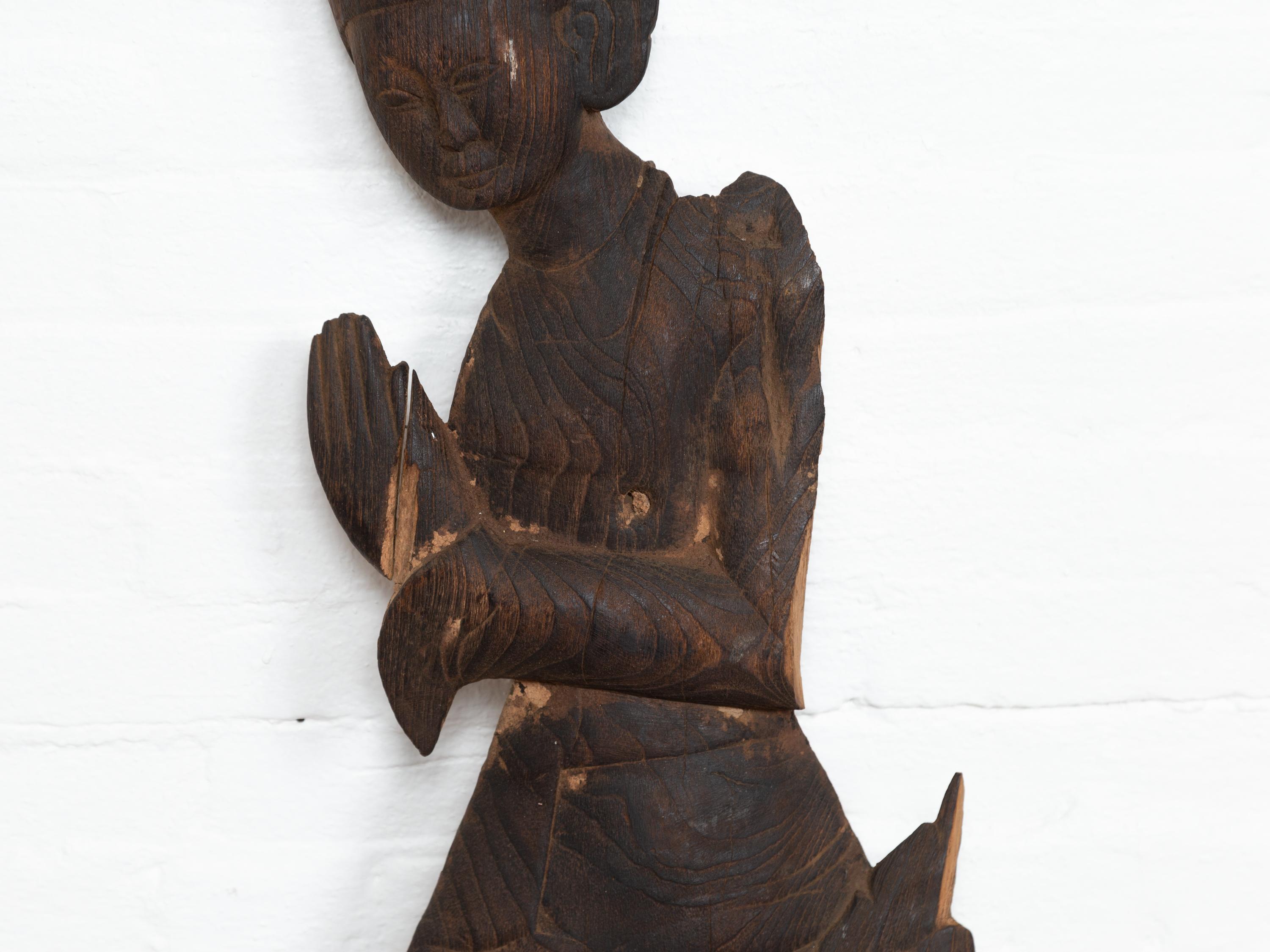 Carved Thai Wooden Sculpture of a Praying Apsara with Dark Brown Patina In Distressed Condition For Sale In Yonkers, NY