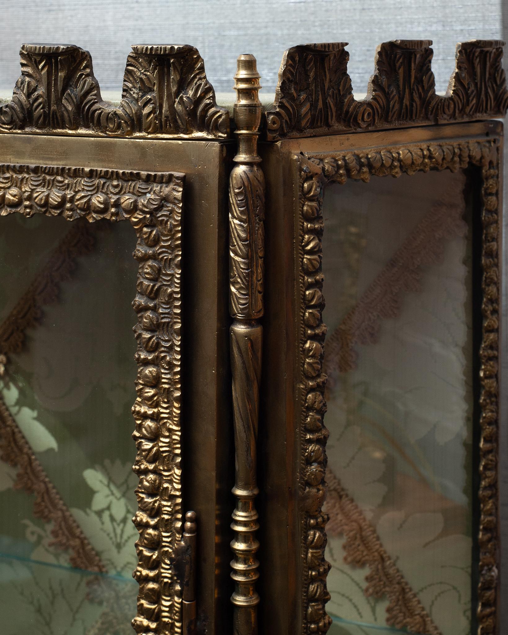 This extravagant antique bronze cabinet is piece worthy of your most precious possessions. The interior back panel is newly upholstered in a pale green silk damask fabric with vintage metallic trim.