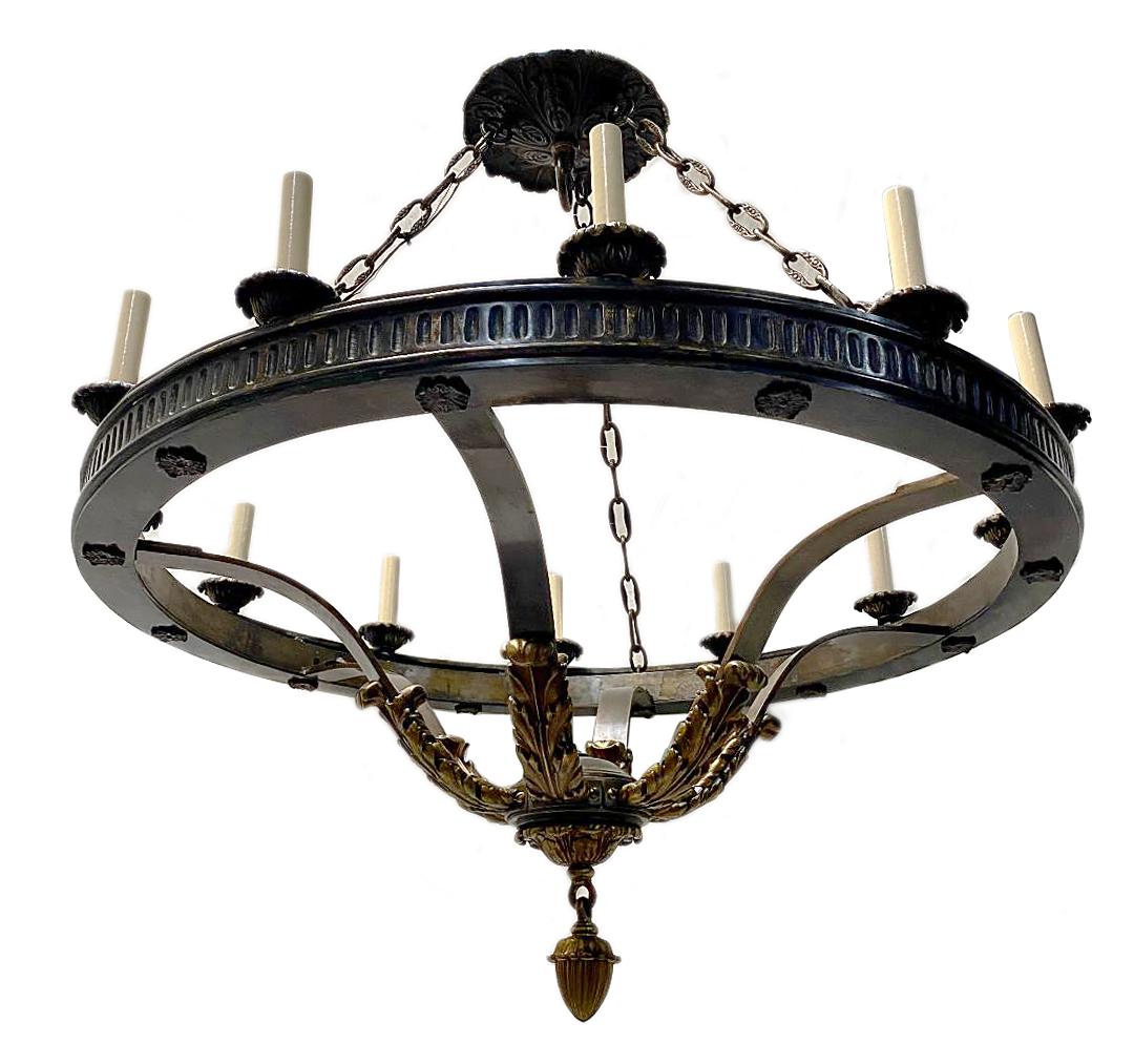 A circa 1900 twelve-light American patinated bronze neoclassic style chandelier.

Measurements:
Height: 38