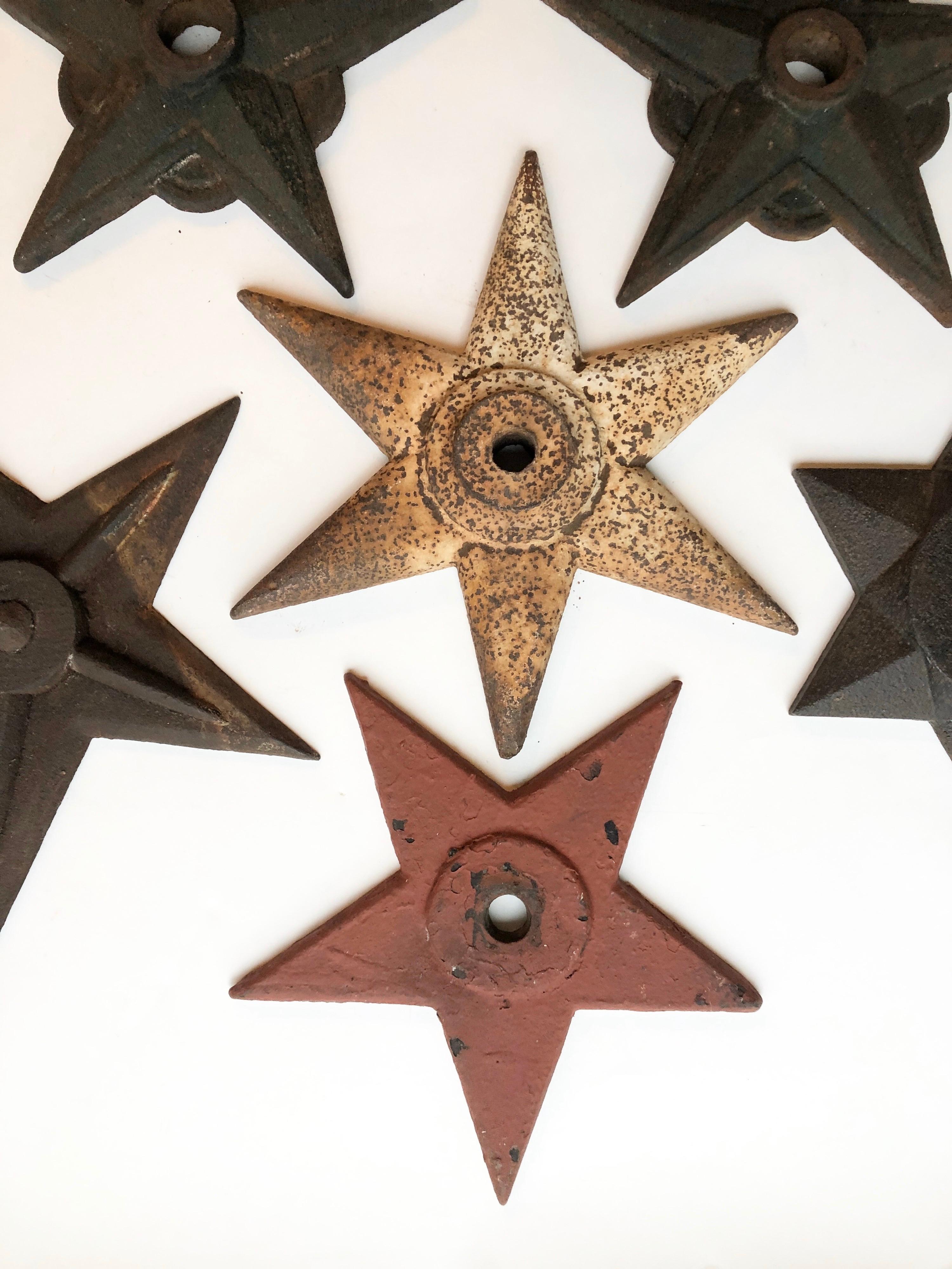 A collection of 7 antique 19th century cast iron decorative star shaped building supports. Used in early brick building construction. Support rods would run the width of a building, capped off with a decorative shaped star that would act as a giant