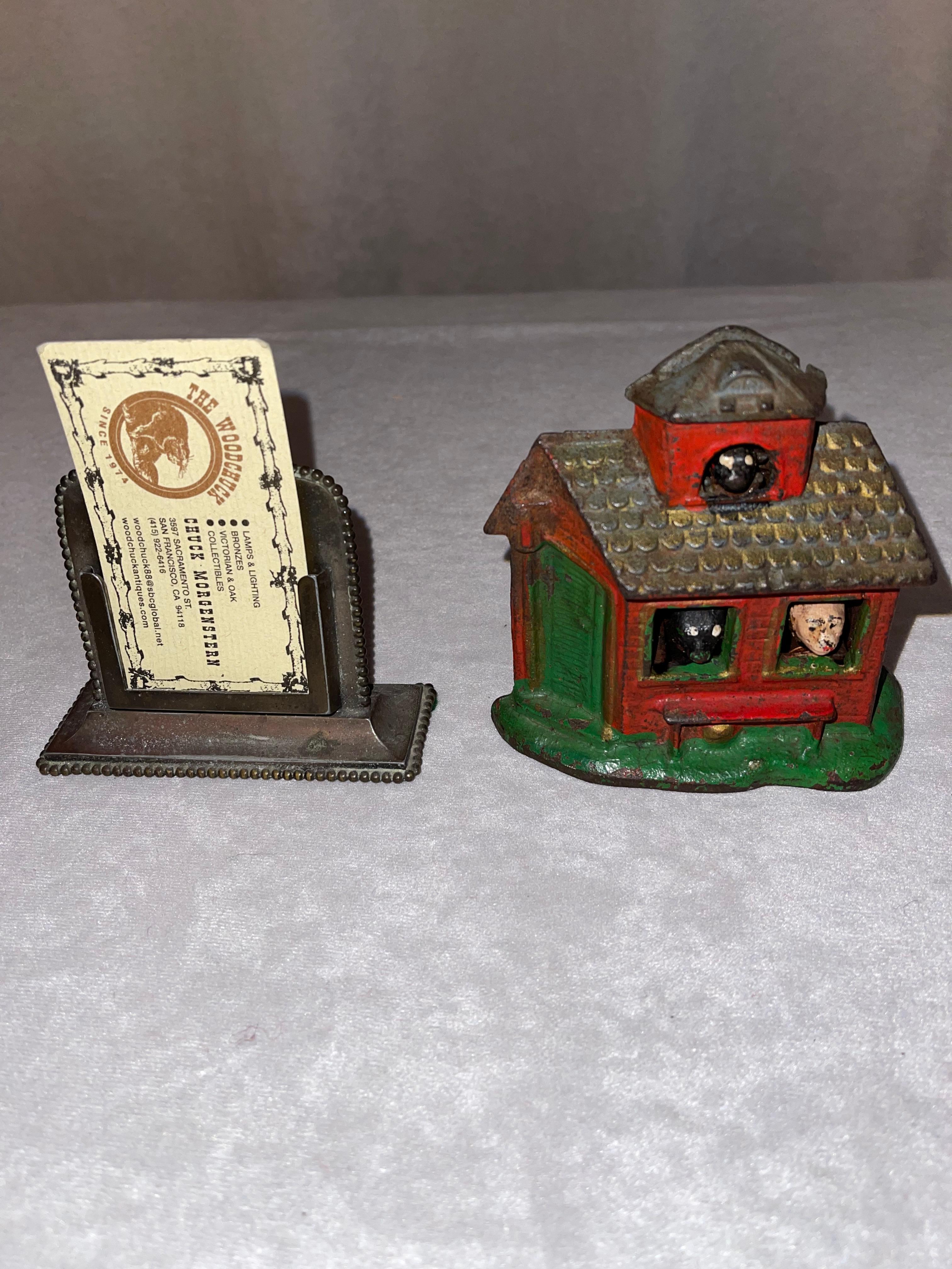 This whimsical cast iron bank should bring a smile to any face. This little house in the woods has 3 animals peeking out of those windows. Nice original paint and no repairs, or breaks.
 A nice gift for the child in all of us.