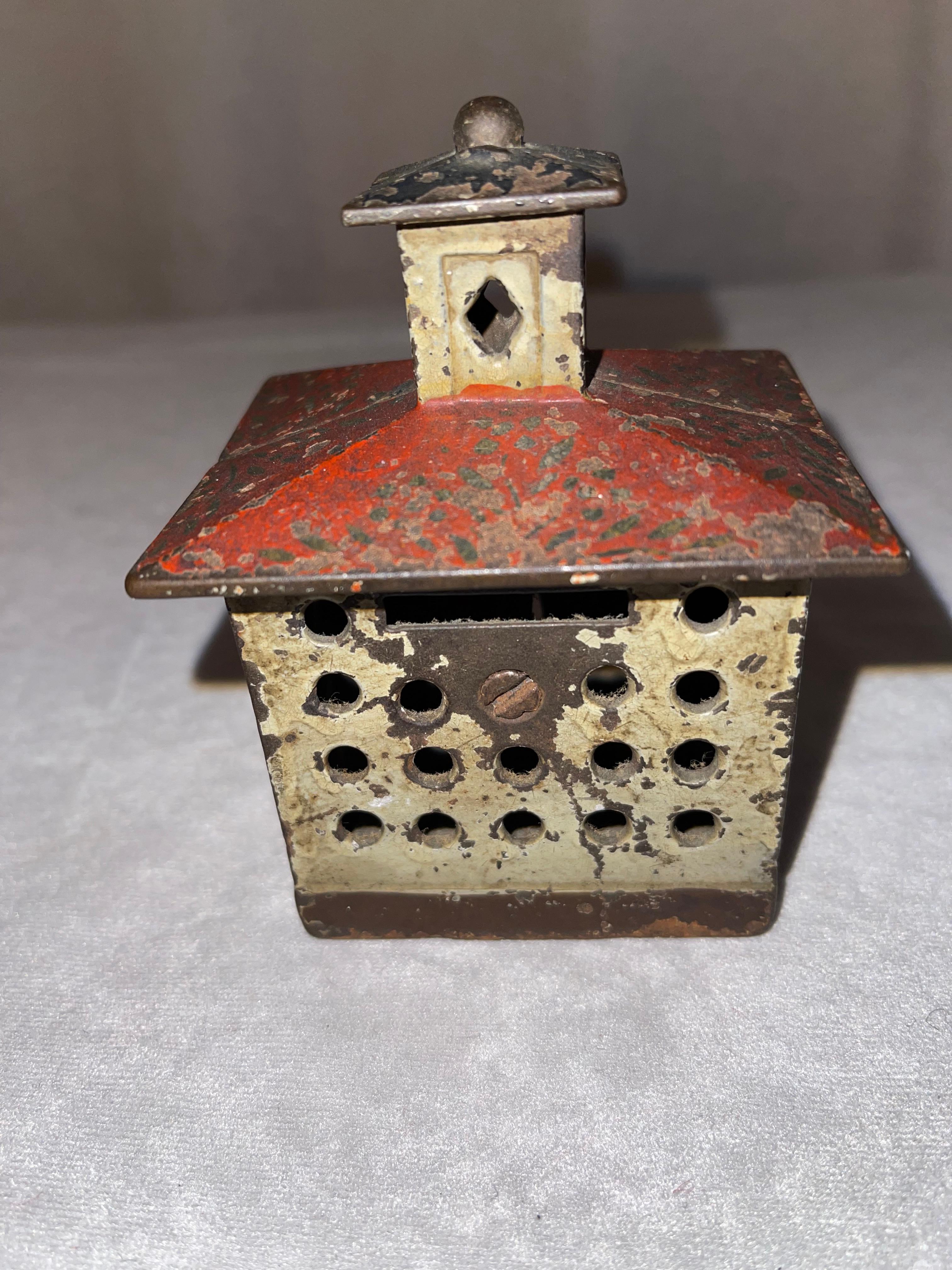 A very nice original cast iron bank, which is a bank building. Not repainted, or touched up. That is most important to any collector. 
 A neat little example of when children were encouraged to save their pennies. What a time it was.