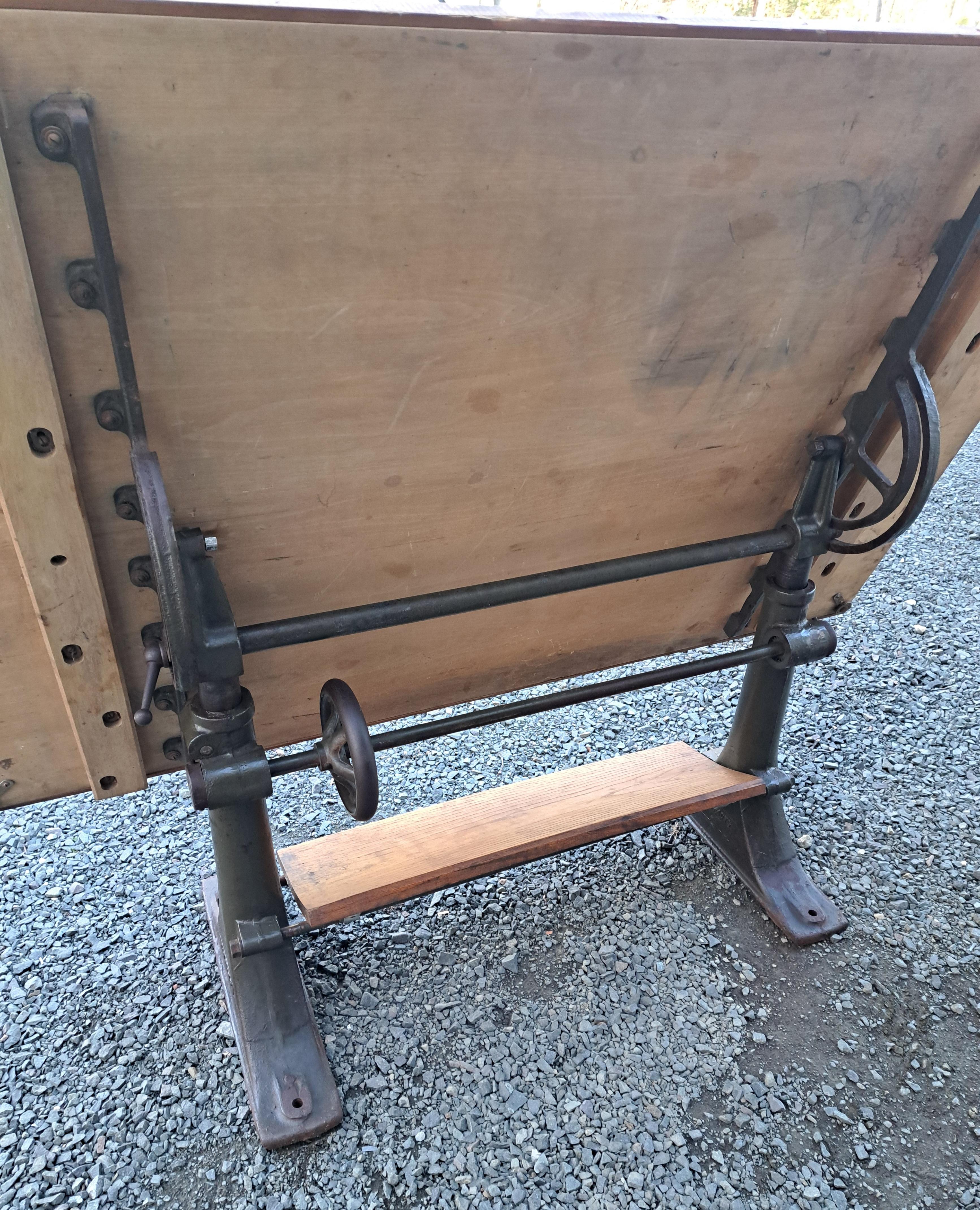 Antique cast iron Base Drafting Table.  Heavy base with a nice clean top.  Originally out of Pratt and Whitney East Hartford Ct.  The top is 60
