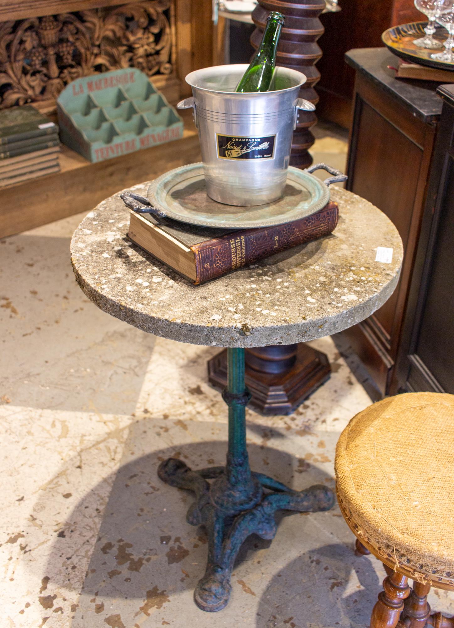 This classically styled bistro table features a cast iron base with a concrete top. We are not certain when the top was added, but we do not believe its original to the piece. However, the base is in wonderful condition and dates to the 1900s, and