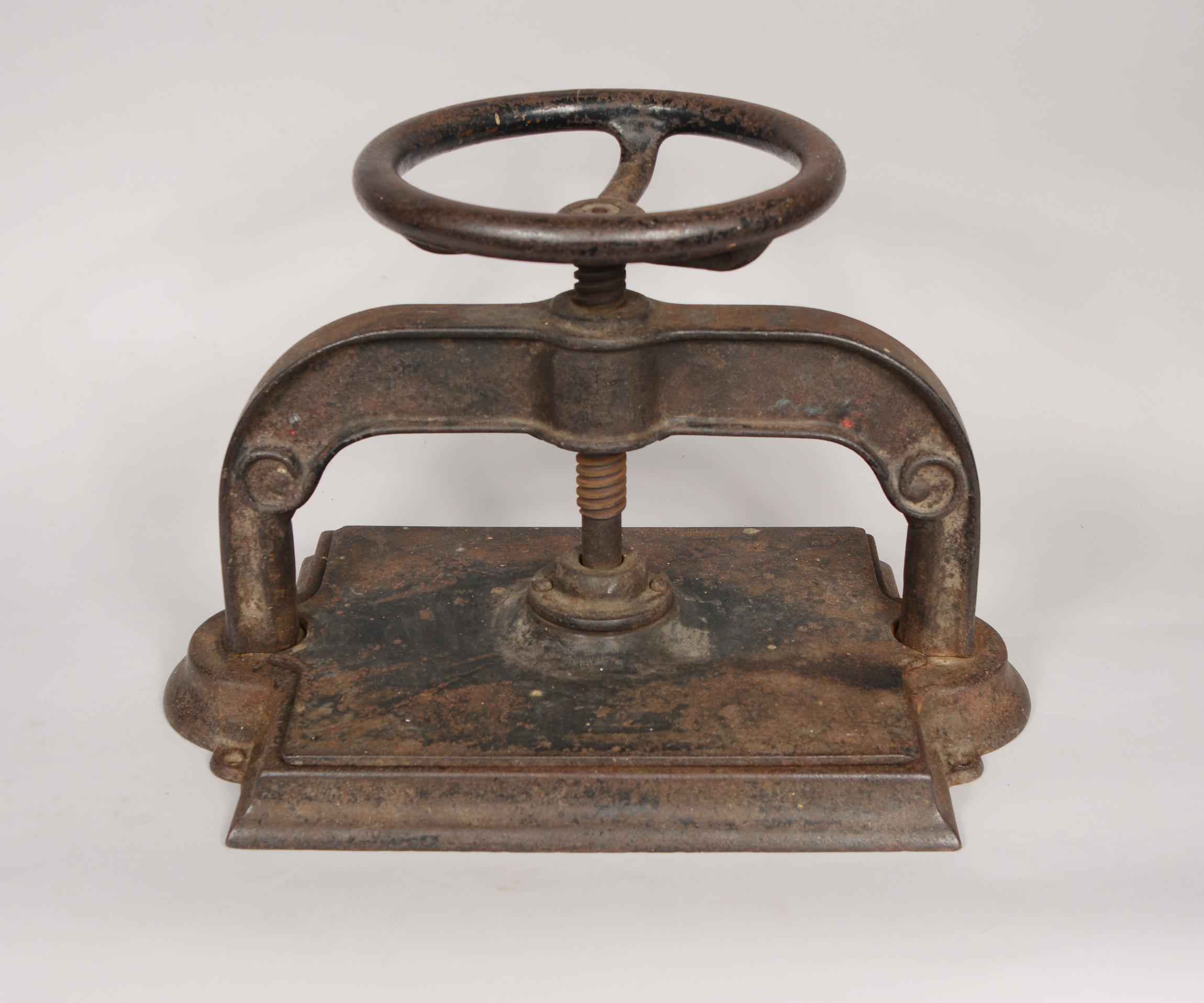 Late 19th or early 20th century book press. This cast iron press has lots of character with paint loss and some surface rust.