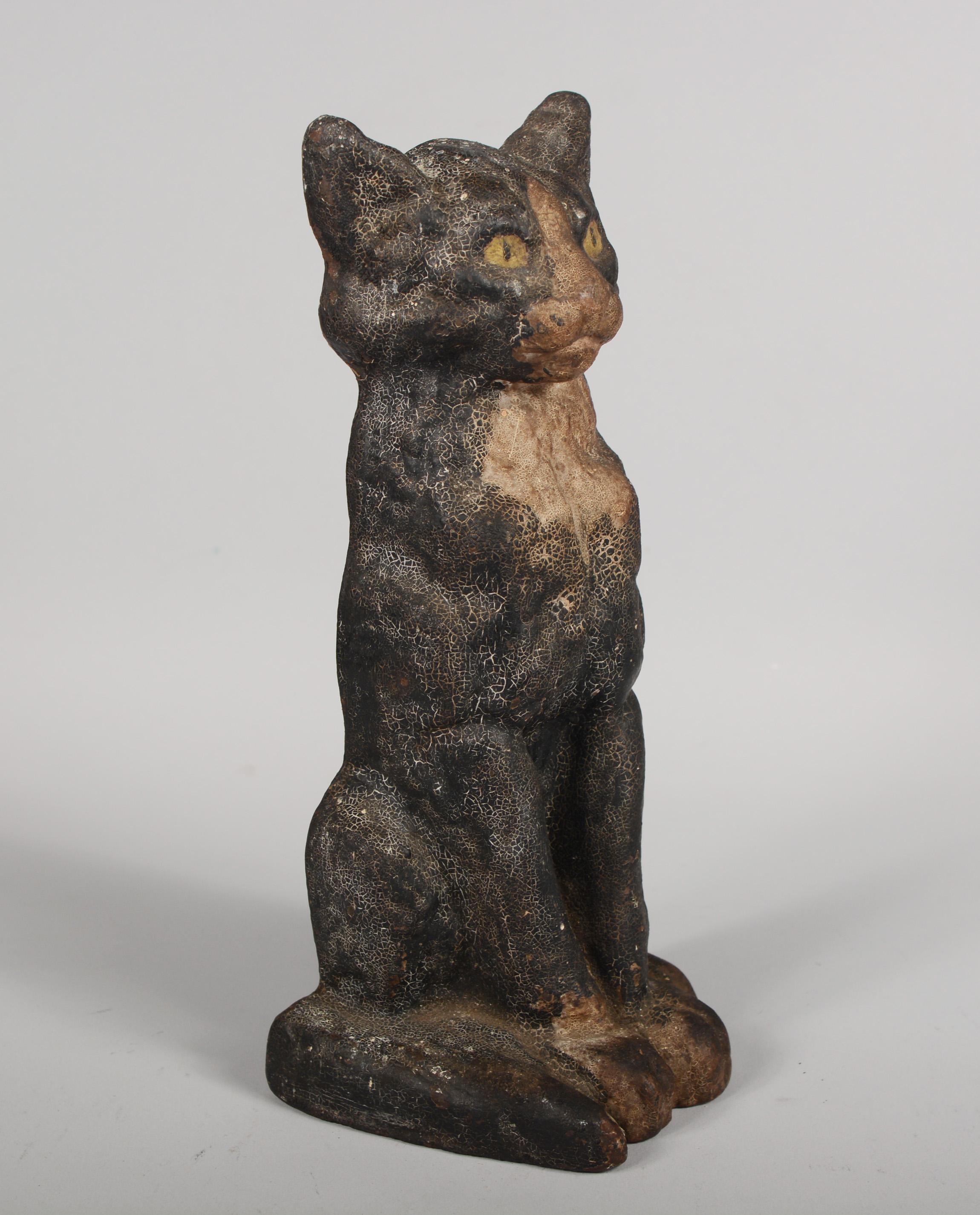 Early 20th century cast iron door stop. This was made by National Foundry, Whitman, Mass. This cat has great patina with original paint with heavy crazing.