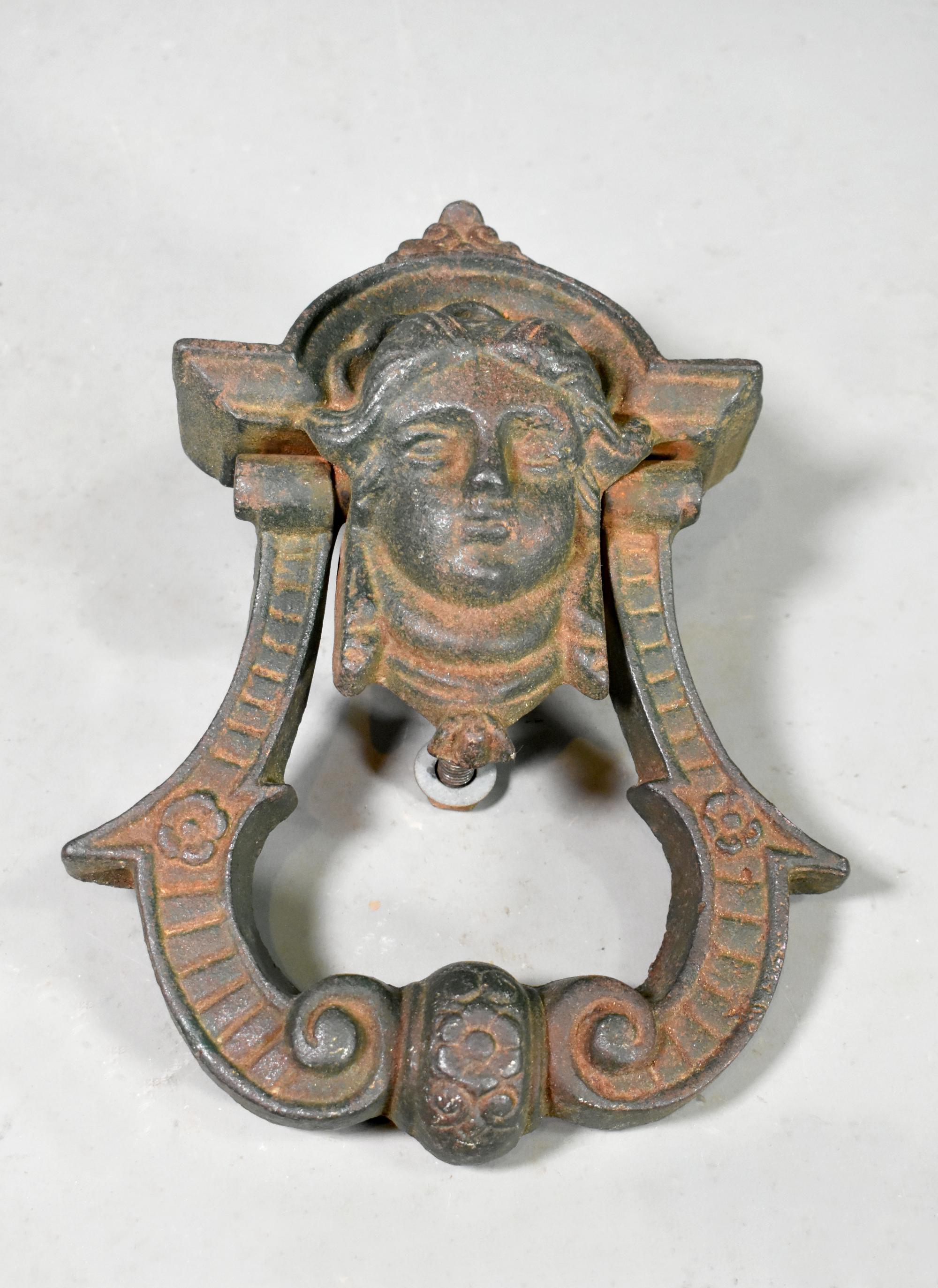 Antique Cast Iron Château Door Knocker 

A large and impressive door knocker originating from a château in Montpellier, South West France. 

Cast in iron with a figure head in the centre with a large swinging arm below, it comes with a separate