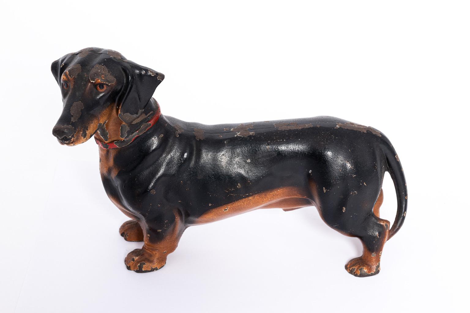 Rare cast iron Hubley doorstop in the shape of a Dachshund manufactured in Lancaster, PA, circa 1930s. The piece features original paint with some paint wear and scratches consistent with age and use. The seams are tight.